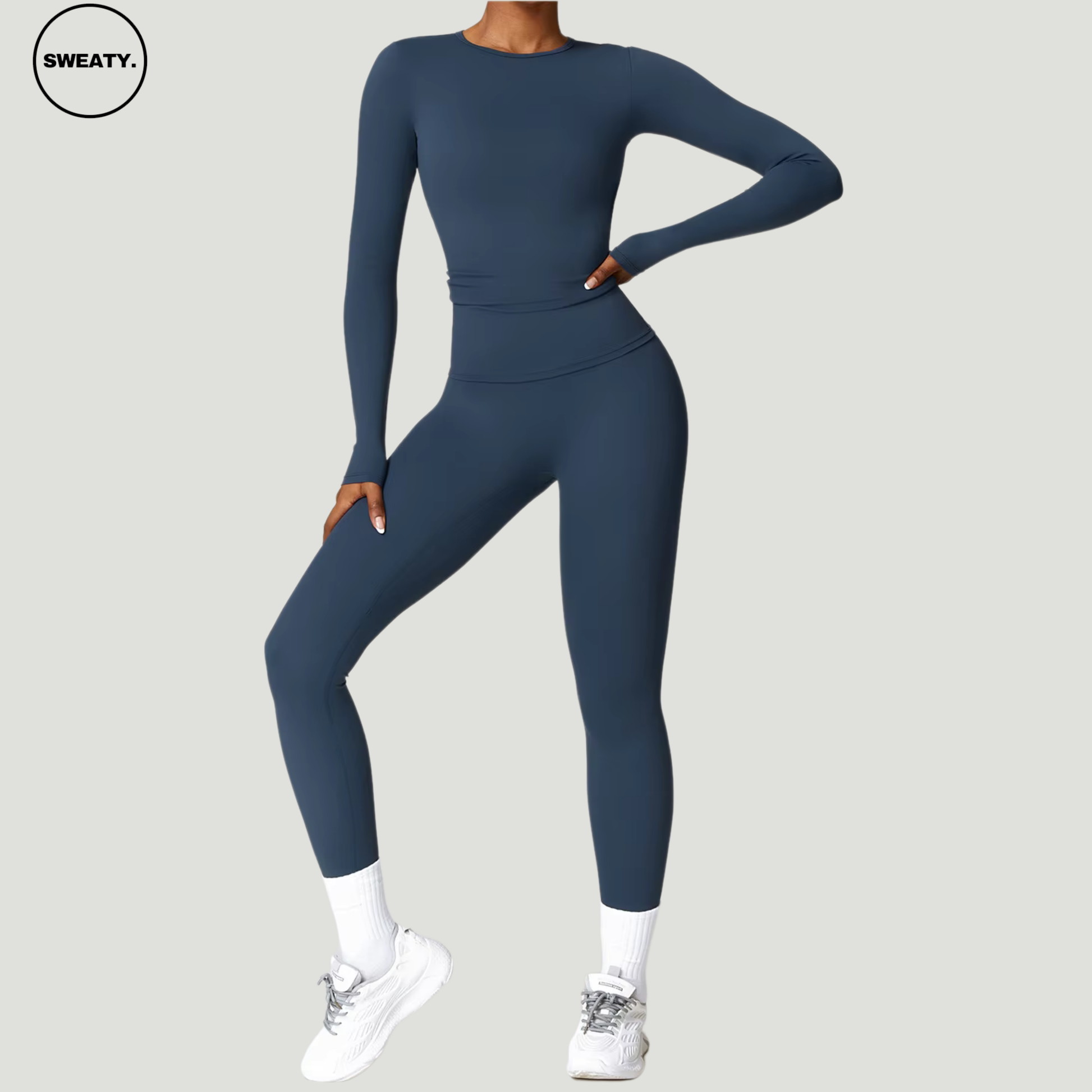 Badge blue seamless yoga set with long sleeves by SWEATY - Women's pose view highlighting the sleek and flexible design, perfect for yoga, gym, and activewear. SWEATY activewear with moisture-wicking and breathable fabric for superior comfort during workouts.