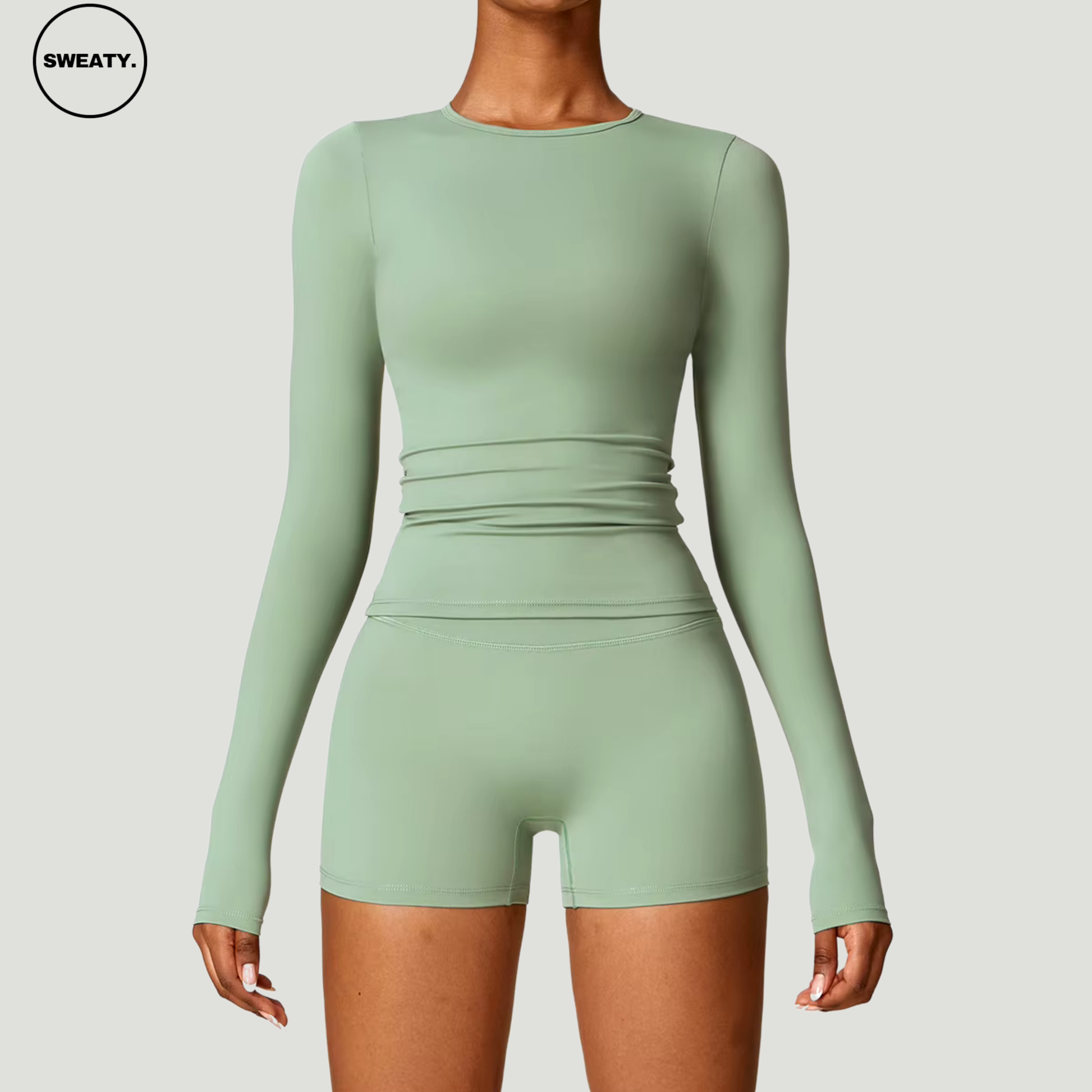 Basil green seamless yoga set with long sleeves by SWEATY - Women's front view highlighting the body-hugging design. Perfect for yoga, fitness, and everyday workouts. SWEATY activewear made from quick-dry and breathable fabric for optimal performance.