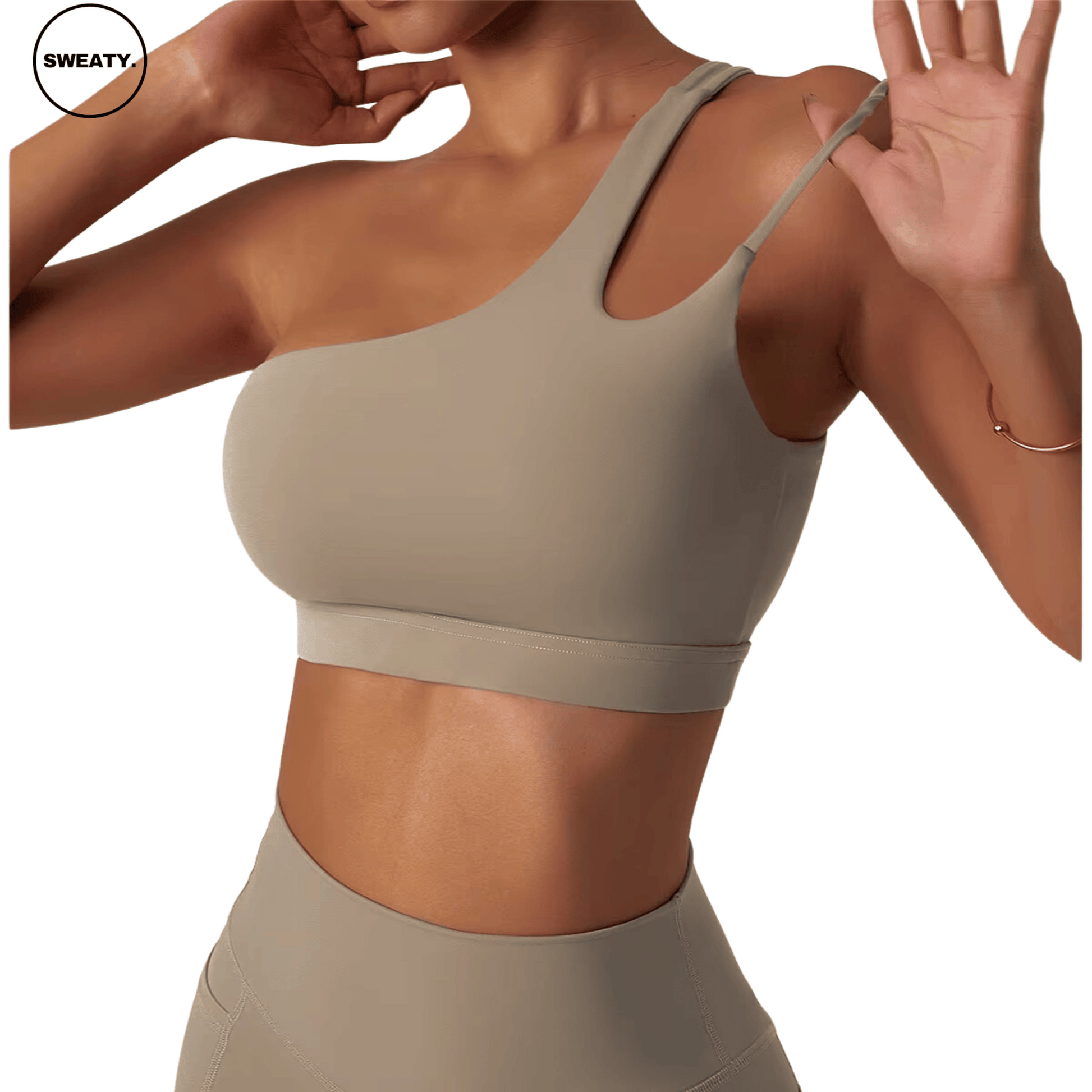 Angled view of a beige Asymmetrical Double Strap Sports Bra by SWEATY, showcasing the unique one-shoulder design and supportive fit, ideal for high-performance workouts.