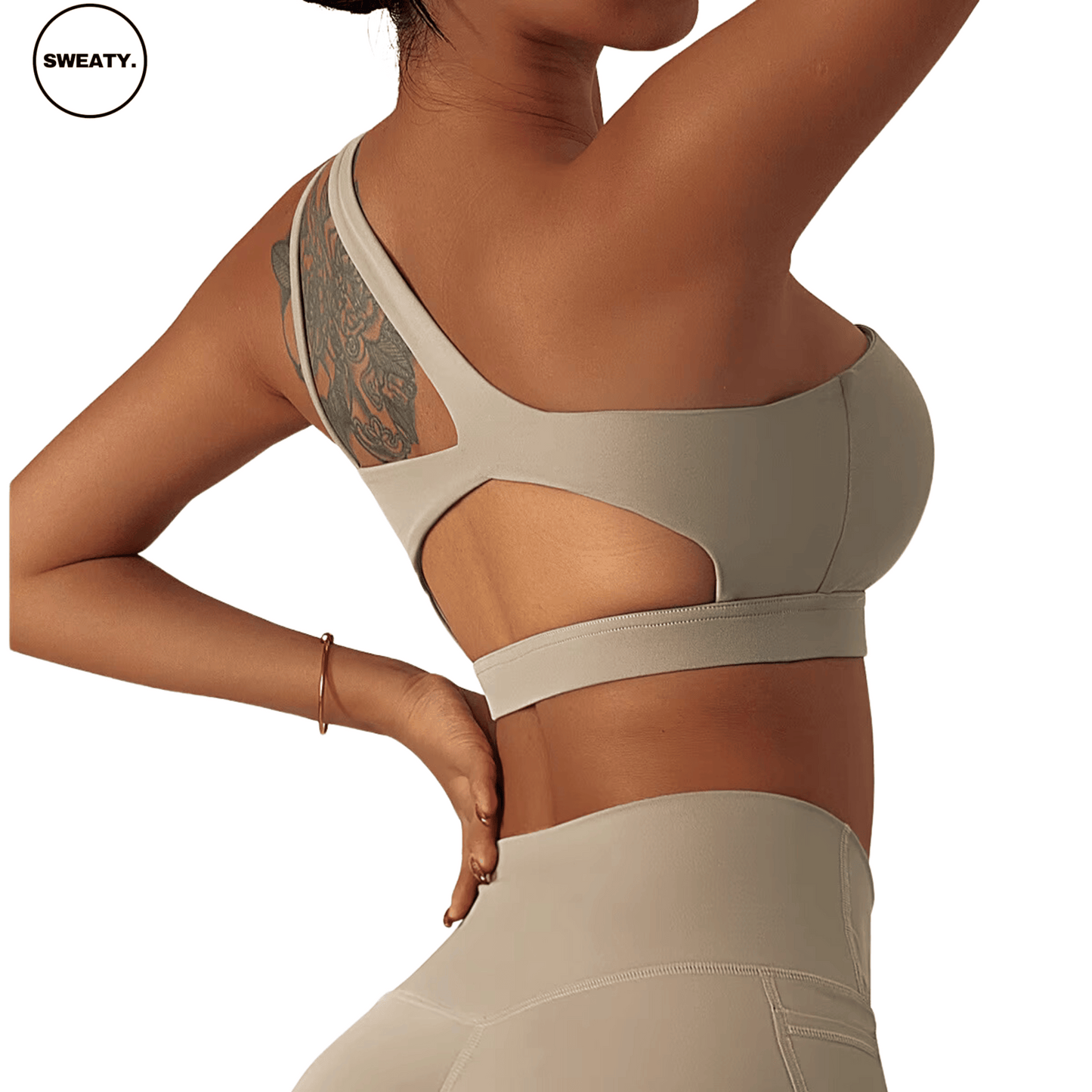 Back view of a beige Asymmetrical Double Strap Sports Bra by SWEATY, highlighting the cut-out back design and supportive fit, ideal for intense workouts and all-day comfort.