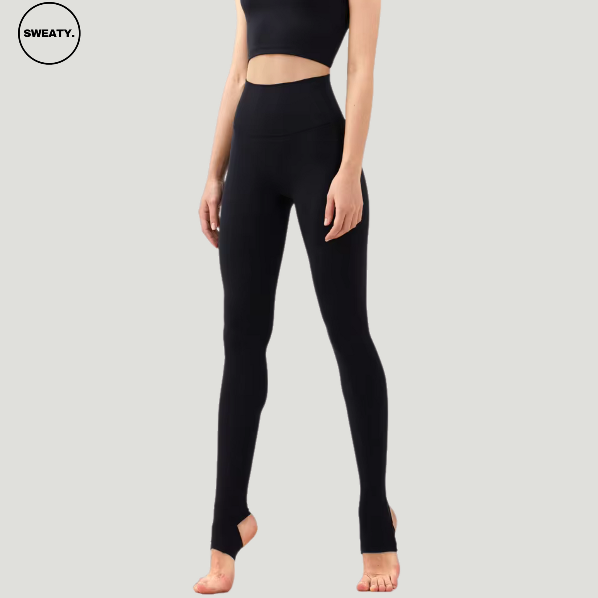 Full-length Black Breathable Stirrup Yoga Leggings by SWEATY, featuring a high-rise waistband and stirrup foot design. The leggings offer a secure fit with breathable, stretchy fabric ideal for yoga, pilates, or dance.