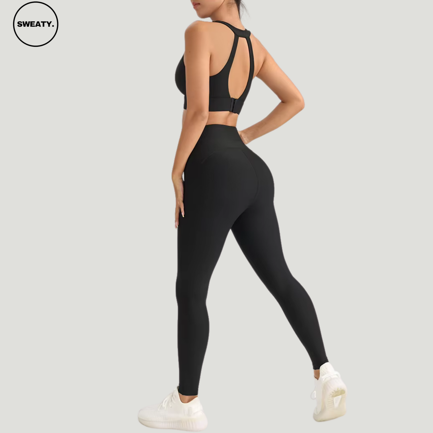 Black-Cross-Yoga-Suit-Back-View-by-SWEATY - Women's bold and vibrant Black Yoga Suit, featuring an elegant cross-back design for enhanced support and style during fitness activities. Perfect for those looking to stand out in the gym with both color and performance.