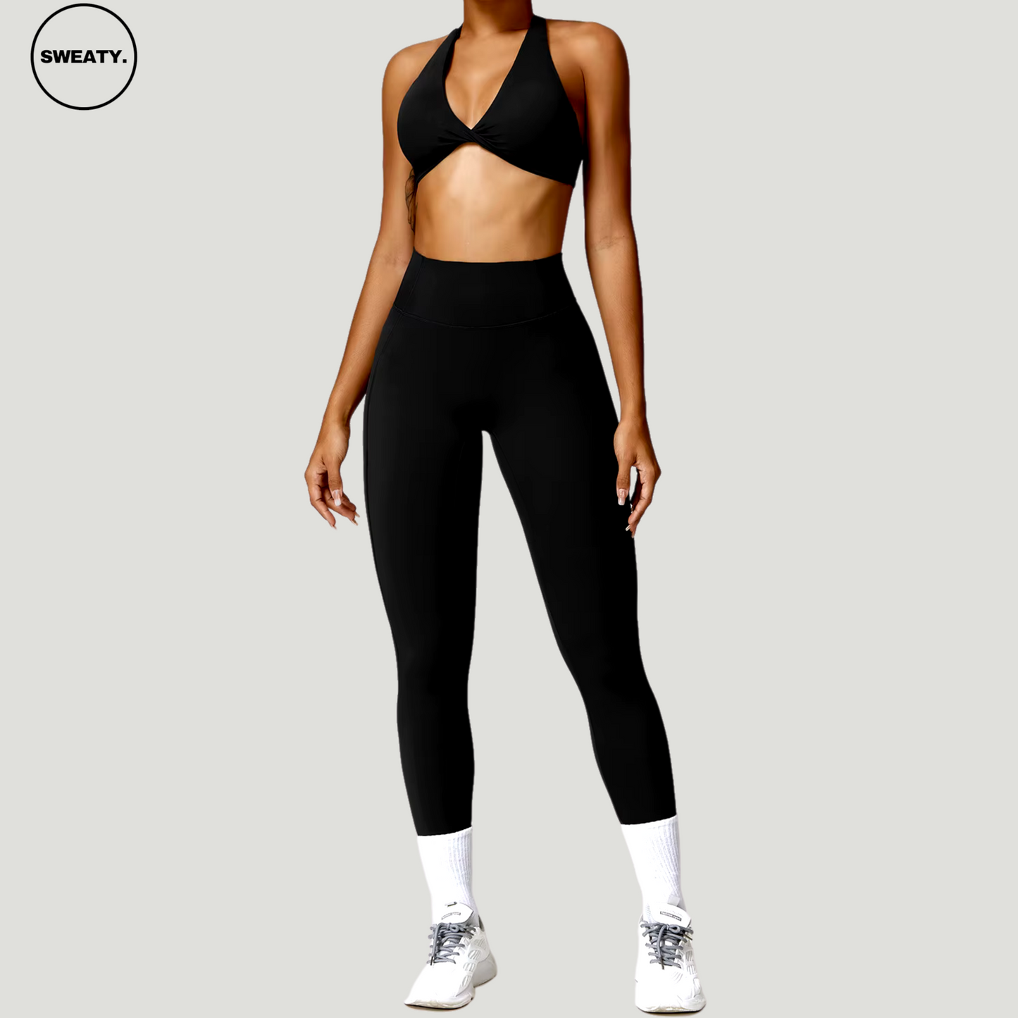 Black Nude Feeling Yoga Set by SWEATY - Women's sleek, all-black yoga sports bra and leggings designed for optimum flexibility and support. Ideal for fitness enthusiasts seeking style and functionality, with moisture-wicking technology for enhanced comfort during workouts.