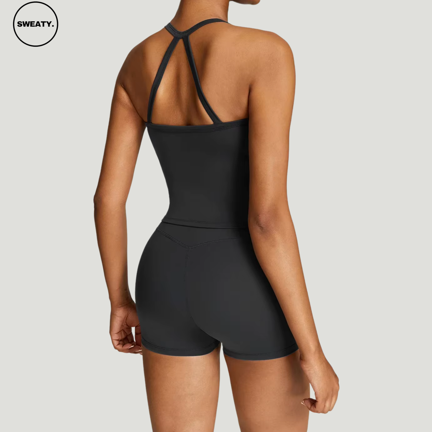 Back view of Black Scrunch Workout Two-Piece by SWEATY - One-shoulder crop top with high-waisted leggings. Designed with quick-dry and breathable fabric for gym, yoga, and fitness routines.