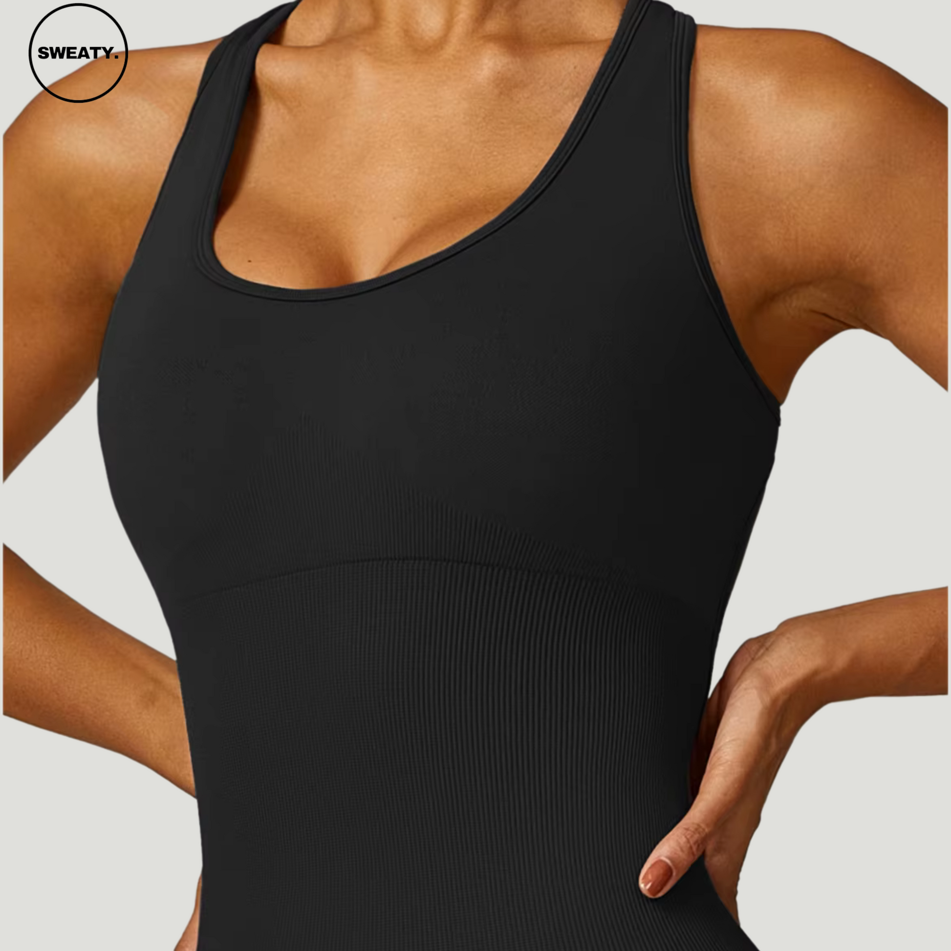 Closeup of Black Seamless Gym Shortie Jumpsuit by SWEATY - Women's fitted jumpsuit with ribbed detailing, designed for fitness and gym. Made from moisture-wicking fabric for optimal comfort and performance.