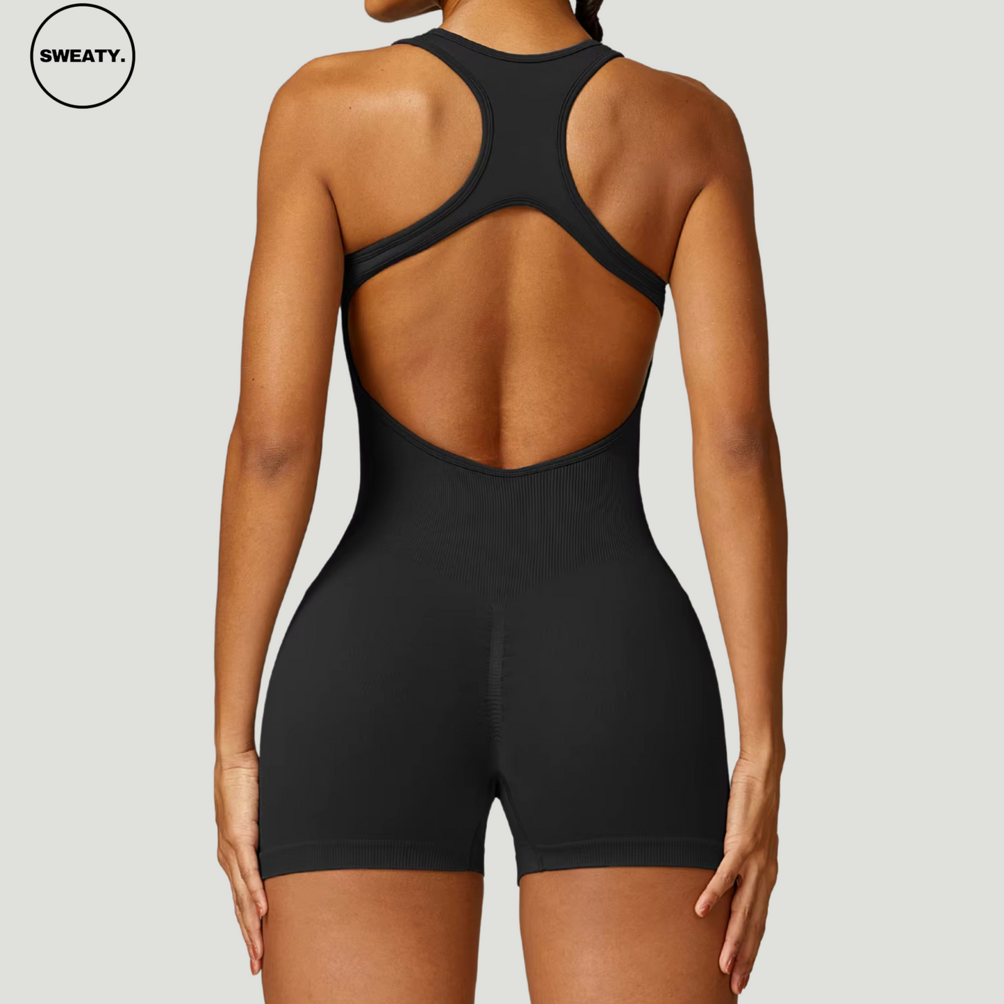 Full-back view of Black Seamless Gym Shortie Jumpsuit by SWEATY - Women's open-back jumpsuit perfect for gym workouts and yoga. Moisture-wicking SWEATY activewear offering breathability and flexibility.