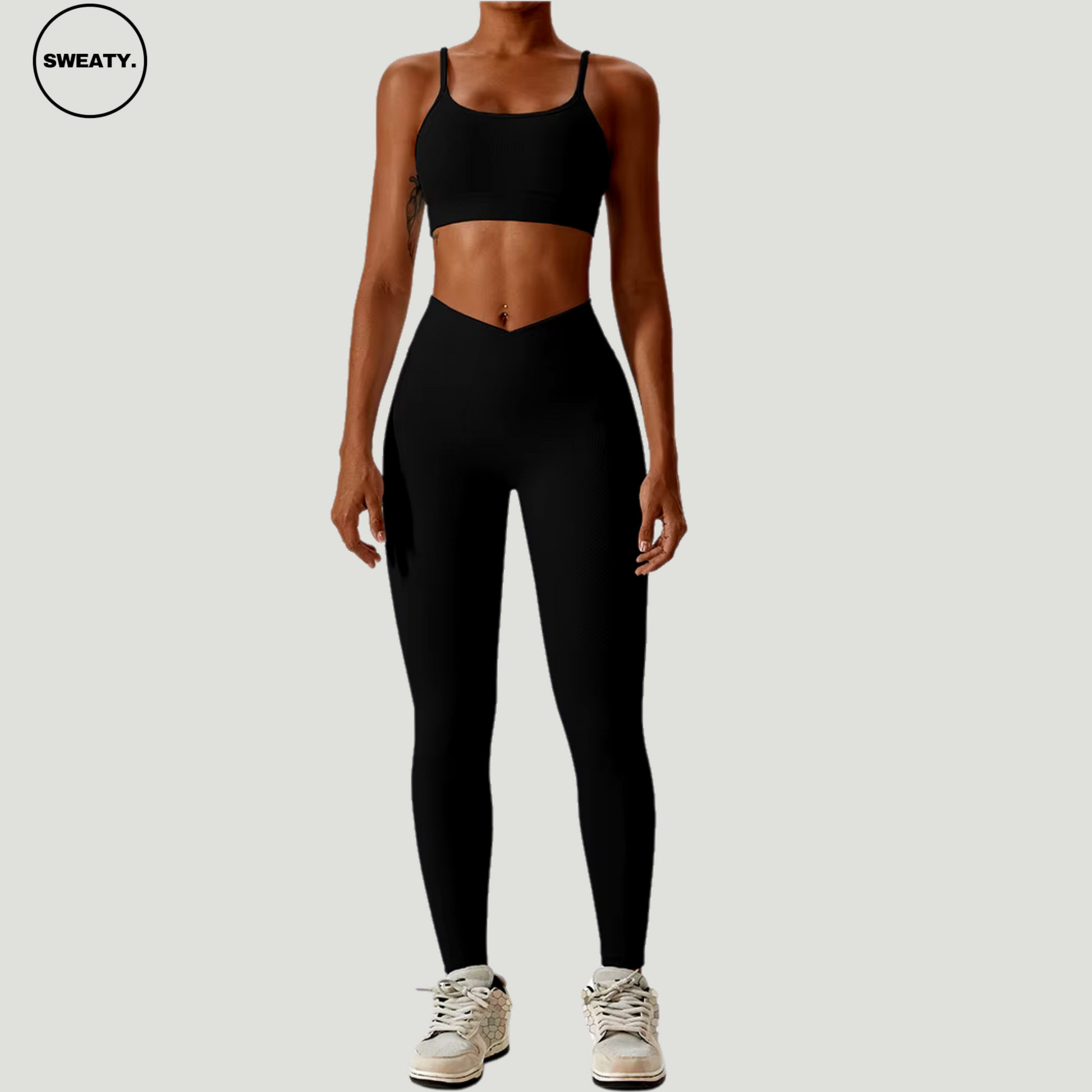 Black seamless sportswear set by SWEATY – front view of sports bra and high-waisted leggings. Designed for comfort and performance with moisture-wicking fabric, ideal for workouts.