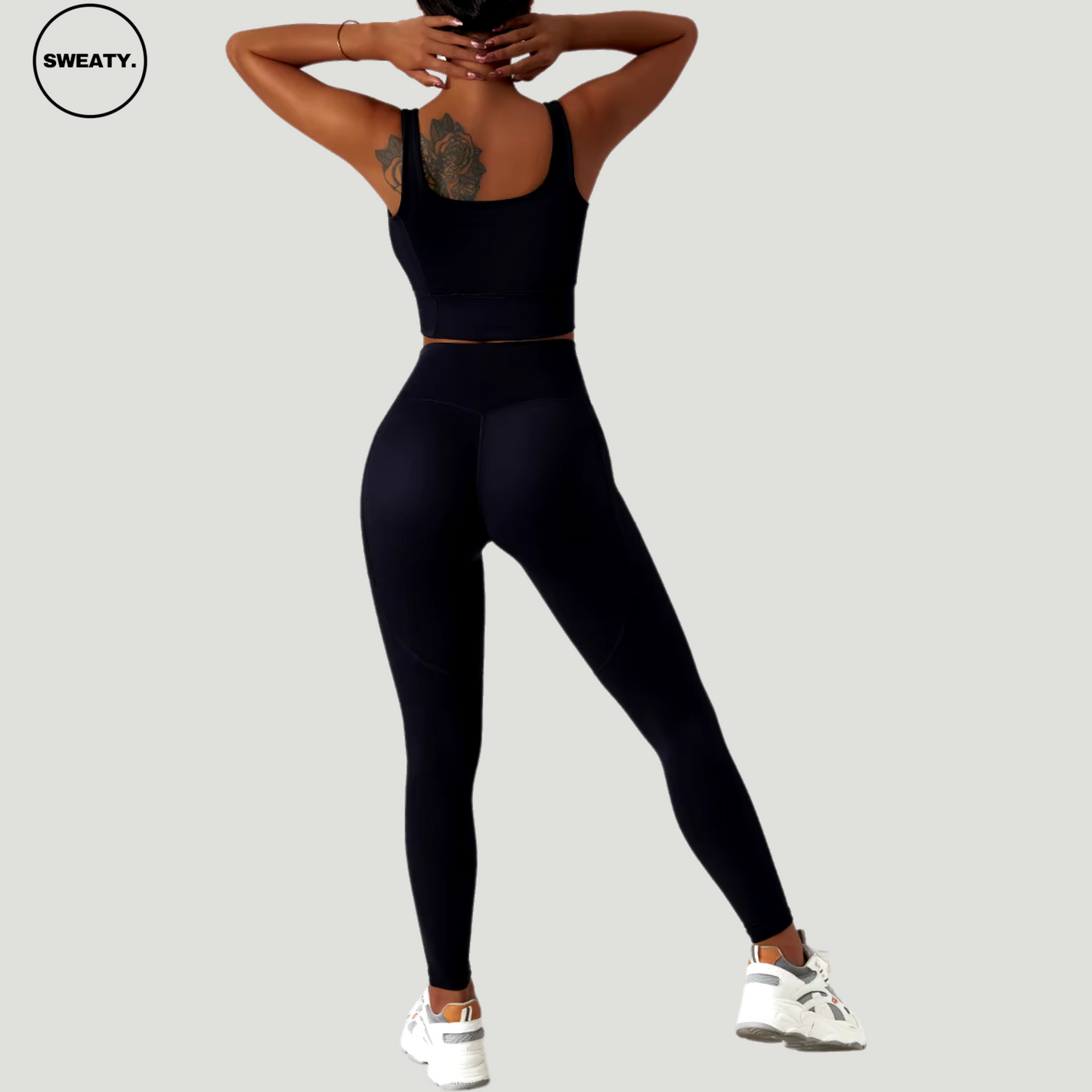 Black seamless tracksuit set by SWEATY - Women's high-waisted leggings and crop top designed for optimal comfort during yoga and fitness activities. Featuring moisture-wicking and breathable fabric.