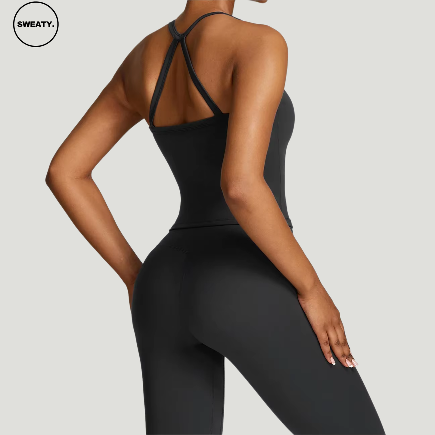 Black seamless yoga set by SWEATY - Women's flexible and breathable workout set featuring a supportive back design. Ideal for yoga, gym, and fitness activities. SWEATY activewear with moisture-wicking fabric for all-day comfort and performance.