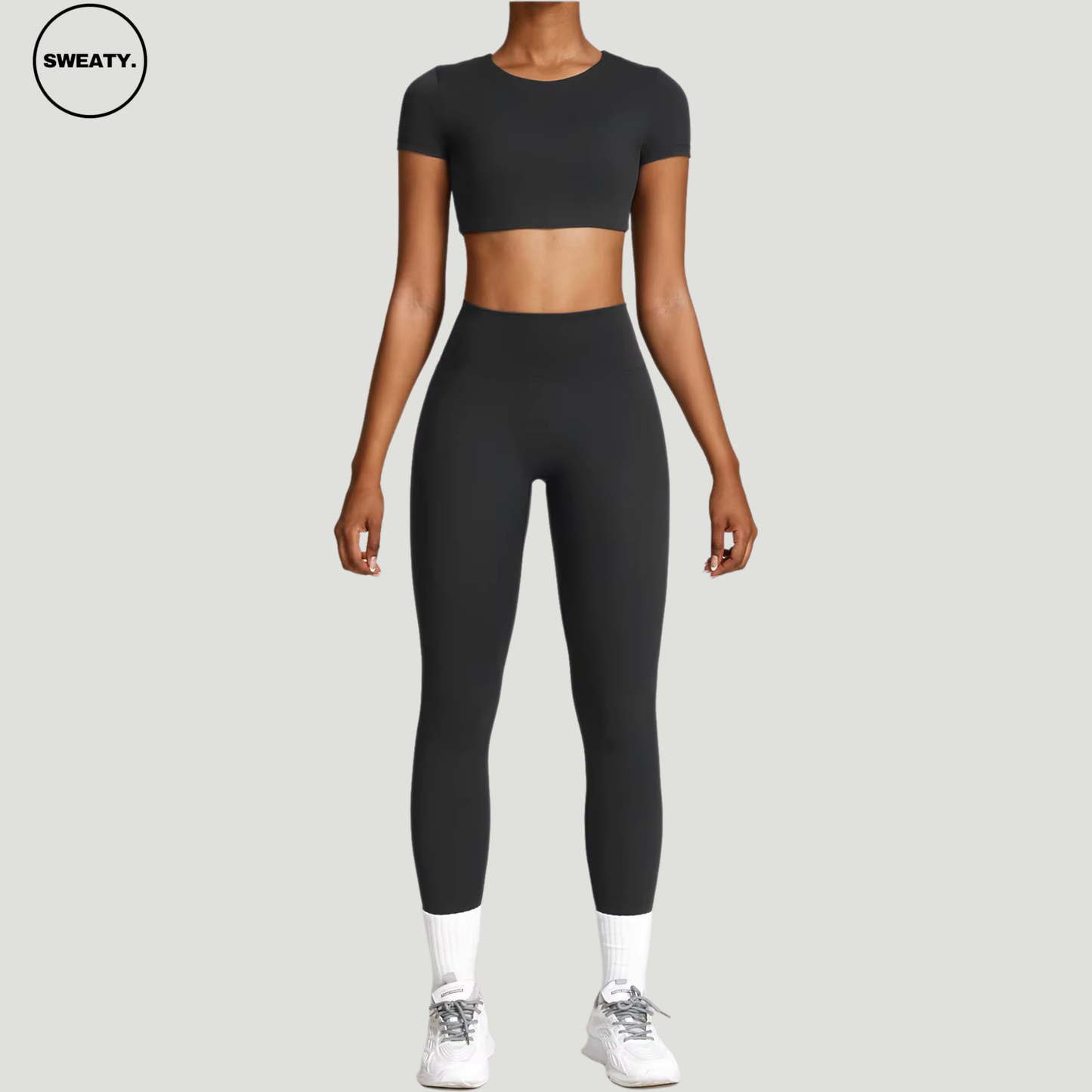 Black seamless yoga set by SWEATY - Women's cropped top front view, designed for gym, yoga, and fitness activities. Lightweight and breathable SWEATY activewear made with moisture-wicking fabric for superior comfort and performance.