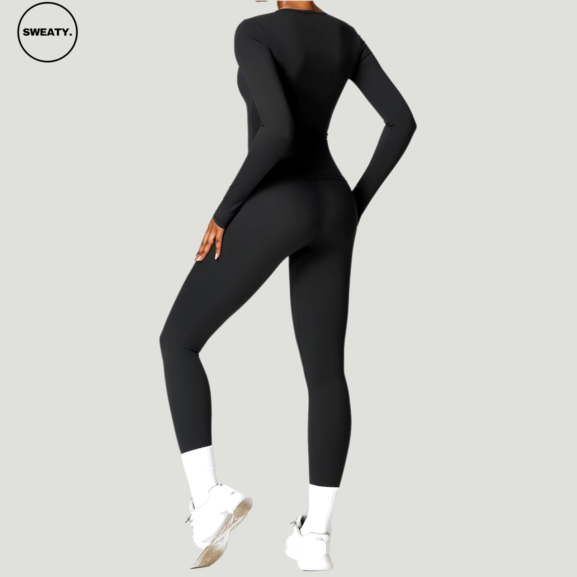 Black seamless yoga set with long sleeves by SWEATY - Women's workout set featuring a back-angle view, showcasing the flexible and breathable fit. Ideal for yoga, running, and fitness activities. SWEATY activewear with moisture-wicking fabric for optimal performance.