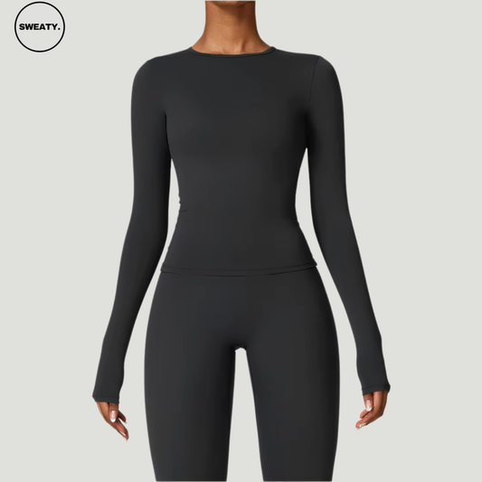 Black seamless yoga set with long sleeves by SWEATY - Women's front close-up view highlighting the sleek and comfortable design. Perfect for yoga, fitness, and everyday activewear. SWEATY activewear crafted from quick-dry, breathable fabric for superior comfort.