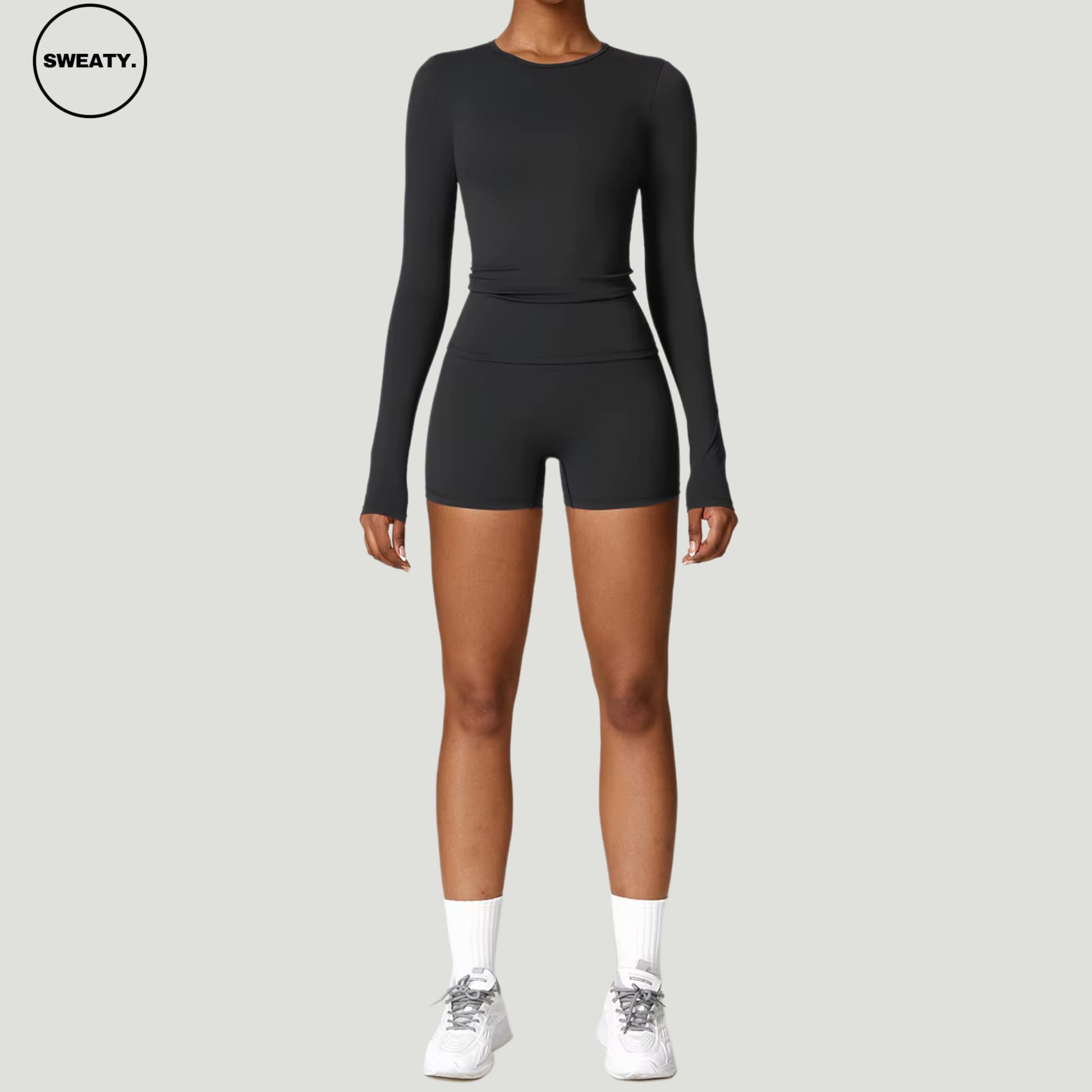 Black seamless yoga set with long sleeves by SWEATY - Women's front view showing the sleek, body-hugging design perfect for yoga, fitness, and gym activities. Lightweight and quick-drying SWEATY activewear for superior performance.