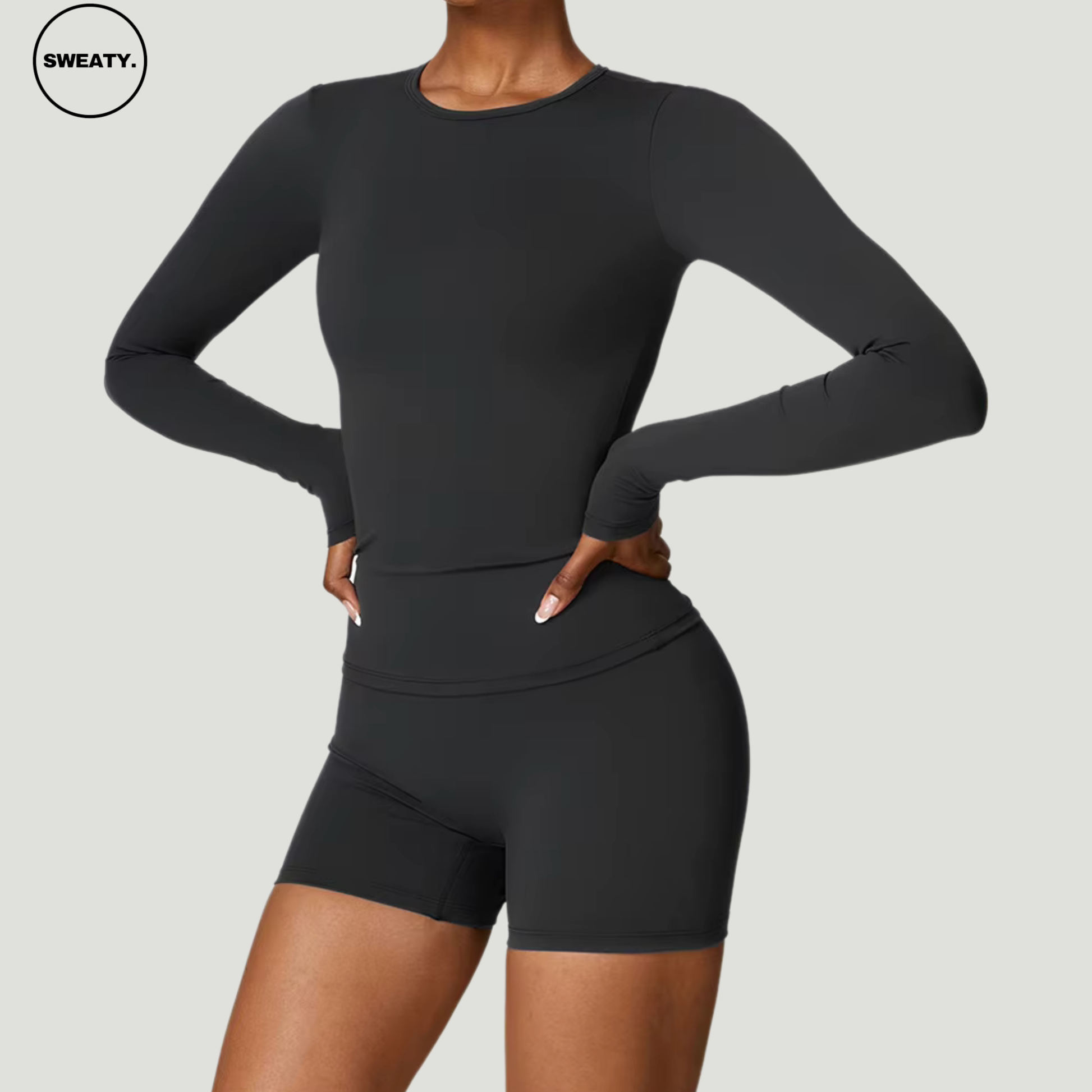 Black seamless yoga set with a long sleeve top by SWEATY - Women's flexible and lightweight workout set with a side view of the sleek design. Perfect for yoga, running, and active workouts. SWEATY activewear with moisture-wicking and quick-dry fabric for enhanced comfort.