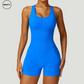 Blue seamless gym shortie jumpsuit by SWEATY - Women's front full close-up view showing the vibrant, seamless fabric and athletic fit. Designed for intense workouts, this jumpsuit provides maximum comfort with its moisture-wicking, flexible material.