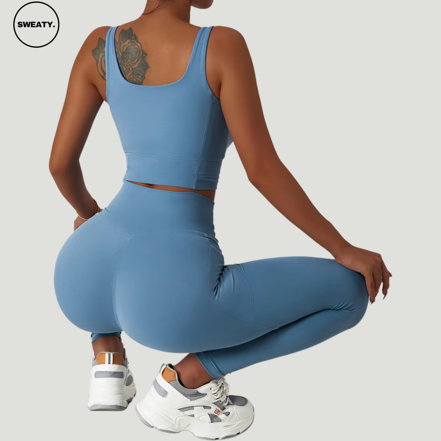 Blue seamless trousers tracksuit set by SWEATY. Women's activewear set with a back view showcasing the flexible and stretchy design. Made with quick-drying, breathable fabric, ideal for yoga, running, and fitness activities.