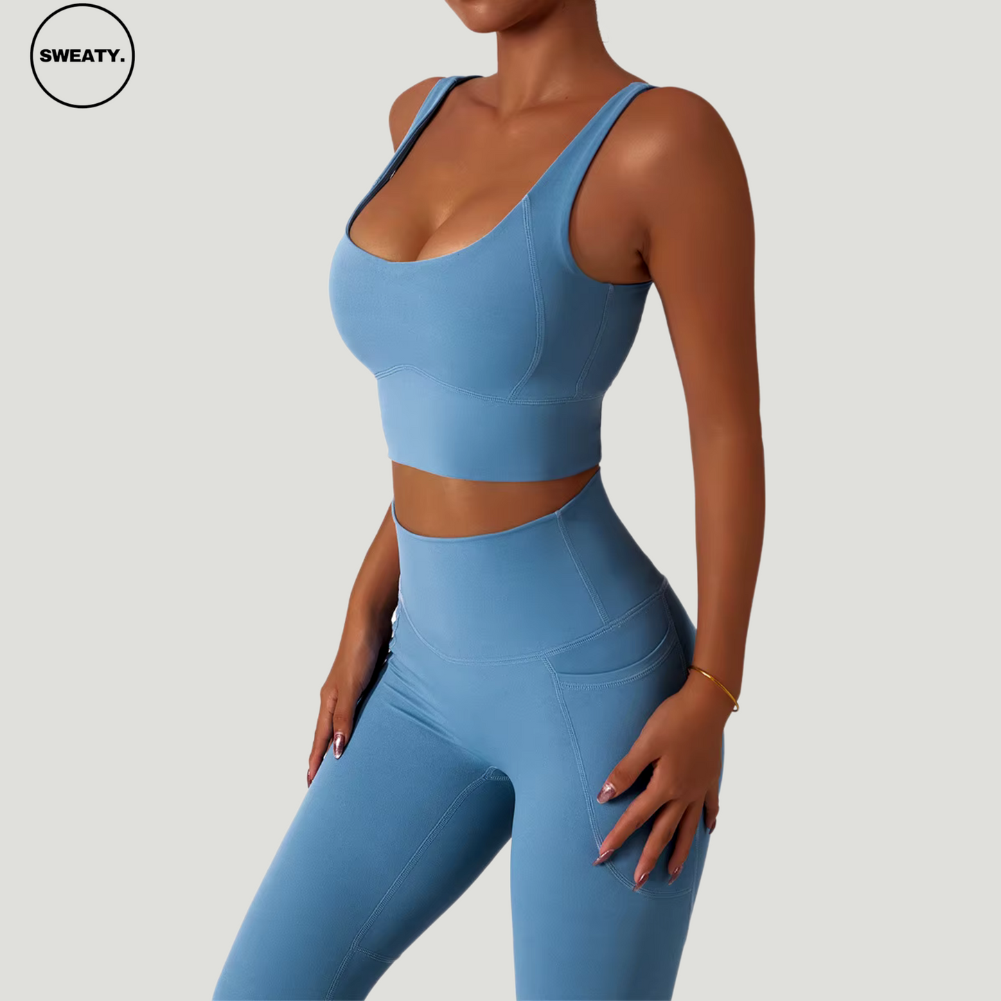 Blue seamless trousers tracksuit set by SWEATY. Women's activewear set featuring a moisture-wicking, breathable fabric, perfect for yoga, fitness, and running. High-waisted leggings with a supportive fit for optimal comfort during workouts.