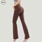 Back view of a model wearing Brown High Waist Slim Yoga Pants by SWEATY, showcasing a flattering fit with a high-waisted design. The pants are full-length with a slight flare at the bottom, offering a sleek, body-hugging silhouette that's ideal for yoga, fitness, or casual wear.