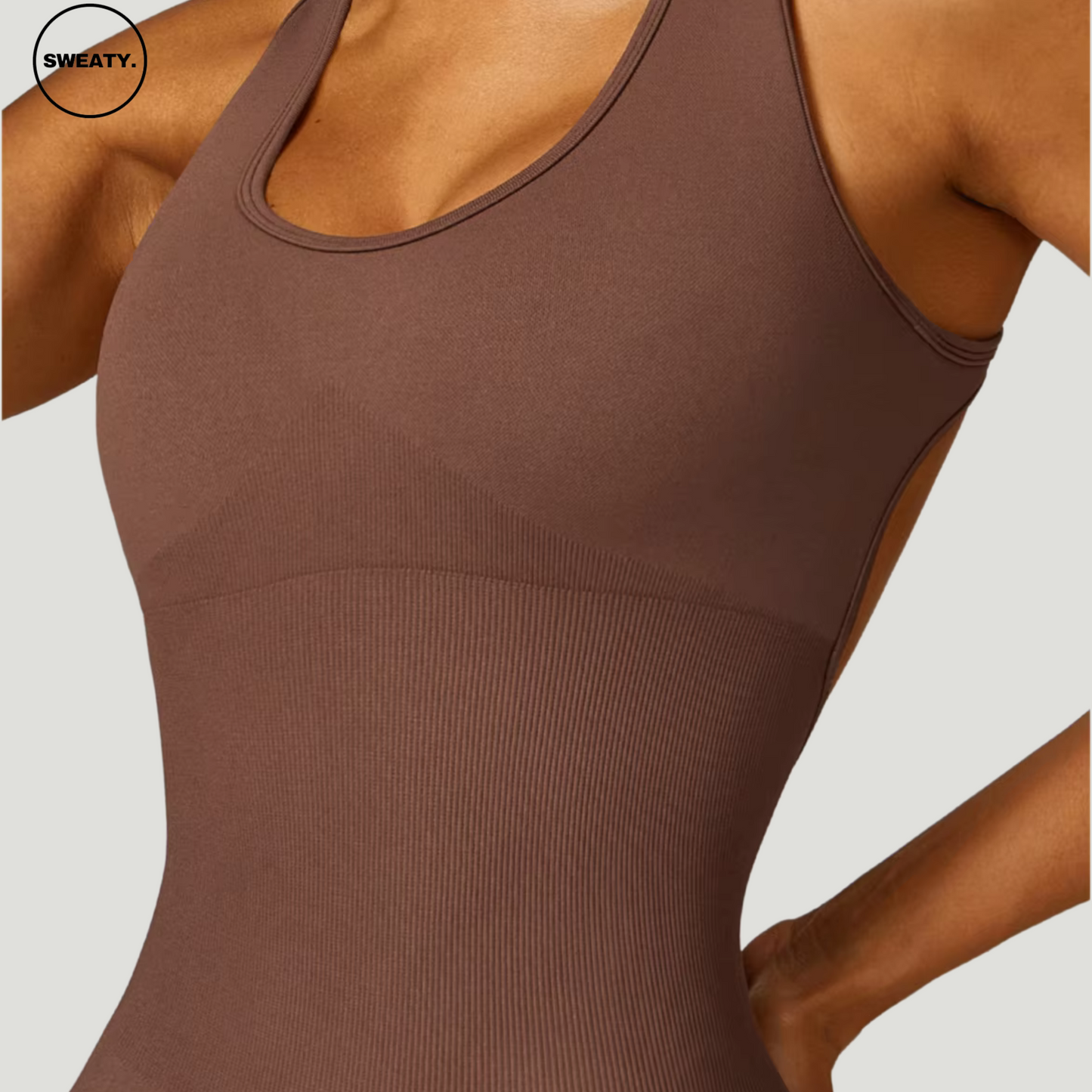 Brown seamless gym shortie jumpsuit by SWEATY - Women's close-up front view showing the seamless, figure-enhancing design. This jumpsuit provides a comfortable, flexible fit with moisture-wicking fabric for intense workouts.