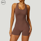 Brown seamless gym shortie jumpsuit by SWEATY - Women's front close-up view showcasing the snug, seamless fabric and athletic fit. Designed for high-intensity workouts, this jumpsuit provides a moisture-wicking, flexible fit.