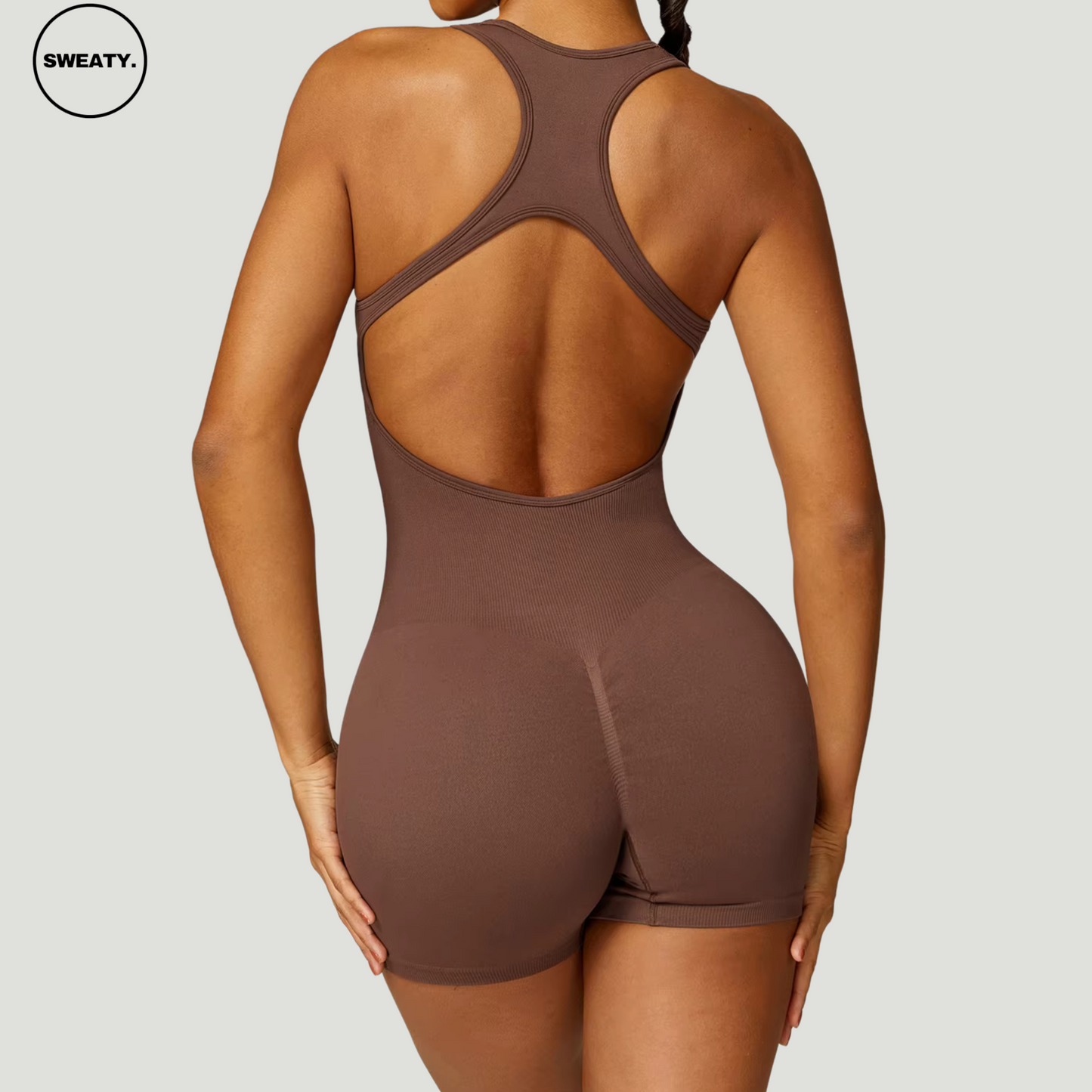 Brown seamless gym shortie jumpsuit by SWEATY - Women's full back view highlighting the open-back racerback design and sculpting fit. The seamless construction ensures flexibility and comfort during workouts or fitness activities.