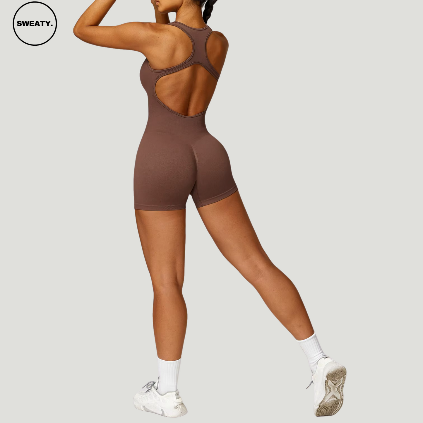 Brown seamless gym shortie jumpsuit by SWEATY - Women's side back view showcasing the racerback and open-back design. This jumpsuit ensures maximum mobility and comfort, ideal for high-intensity workouts.