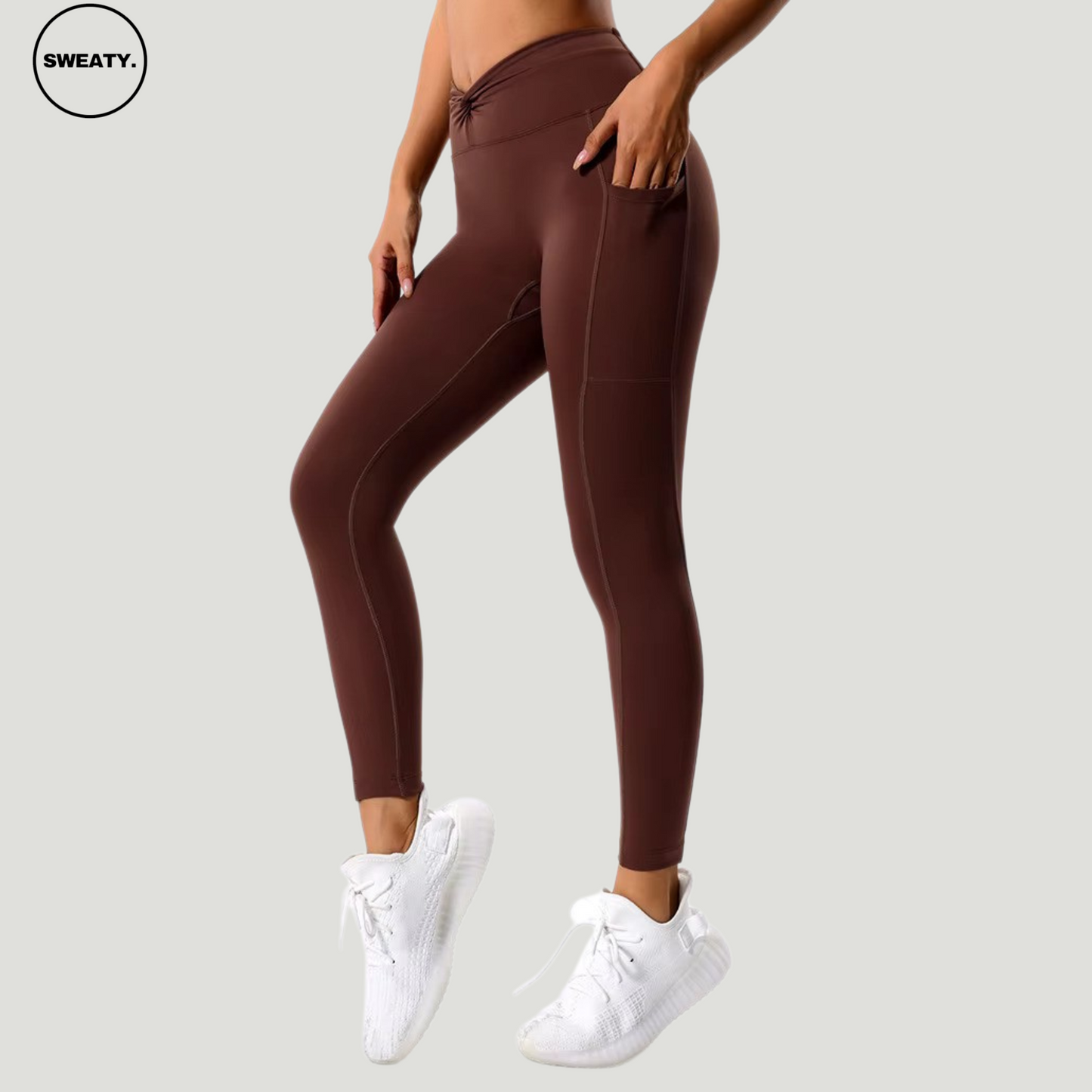 Side view of the Coffee Hips Yoga Legging by SWEATY, showcasing the high-waist design with side pockets for convenience. Ideal for yoga and fitness activities, paired with white sneakers for a stylish and comfortable workout look.