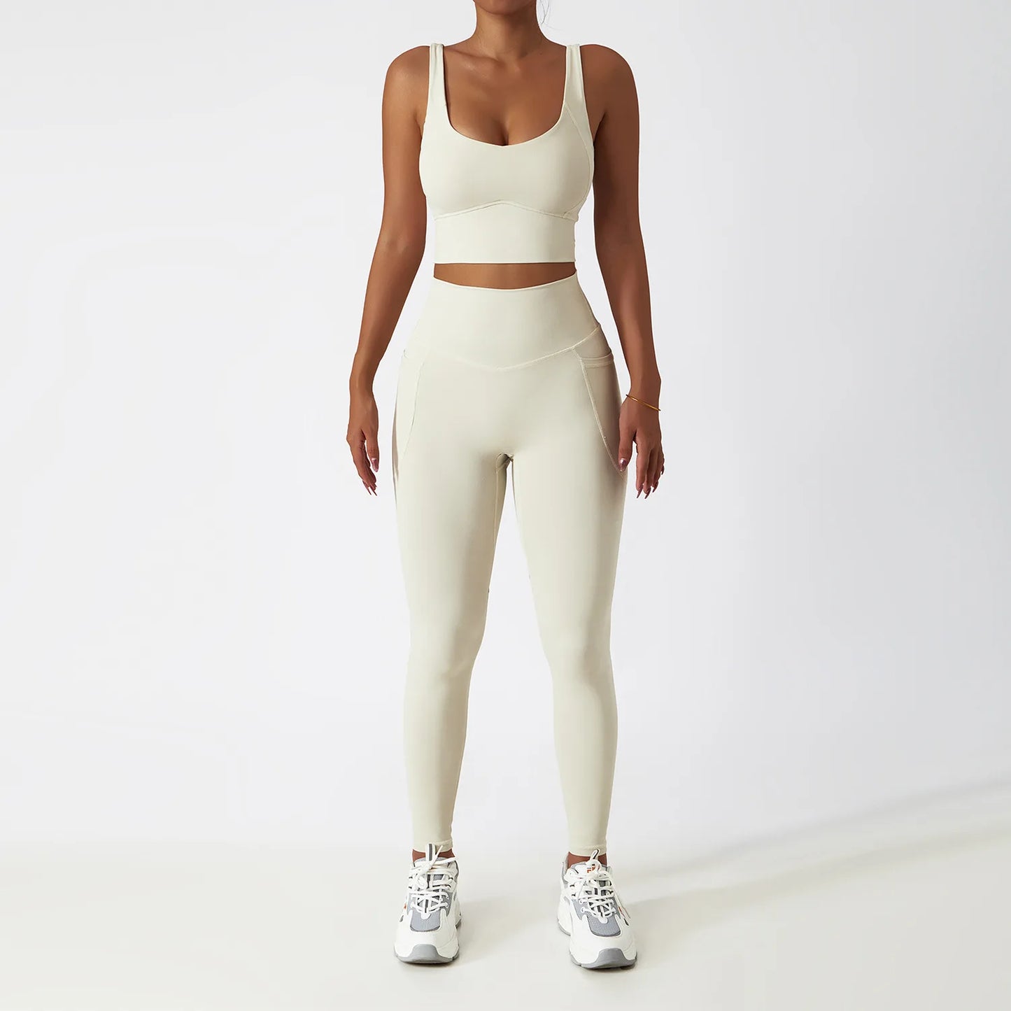 Cream seamless tracksuit set by SWEATY - Women's high-waist leggings and matching supportive sports bra, crafted with moisture-wicking and breathable fabric. Ideal for yoga, running, and fitness activities, offering flexibility and comfort during workouts.