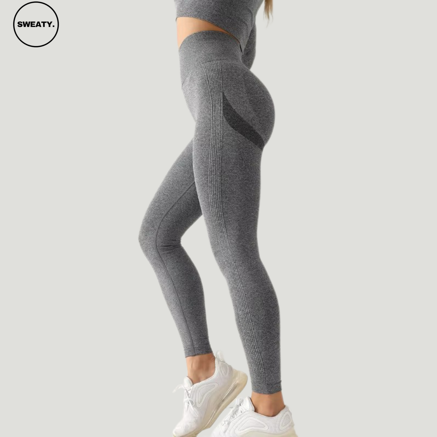 Side angle view of Dark Gray seamless high-waist leggings by SWEATY, showing the contouring details and comfortable, figure-hugging design.