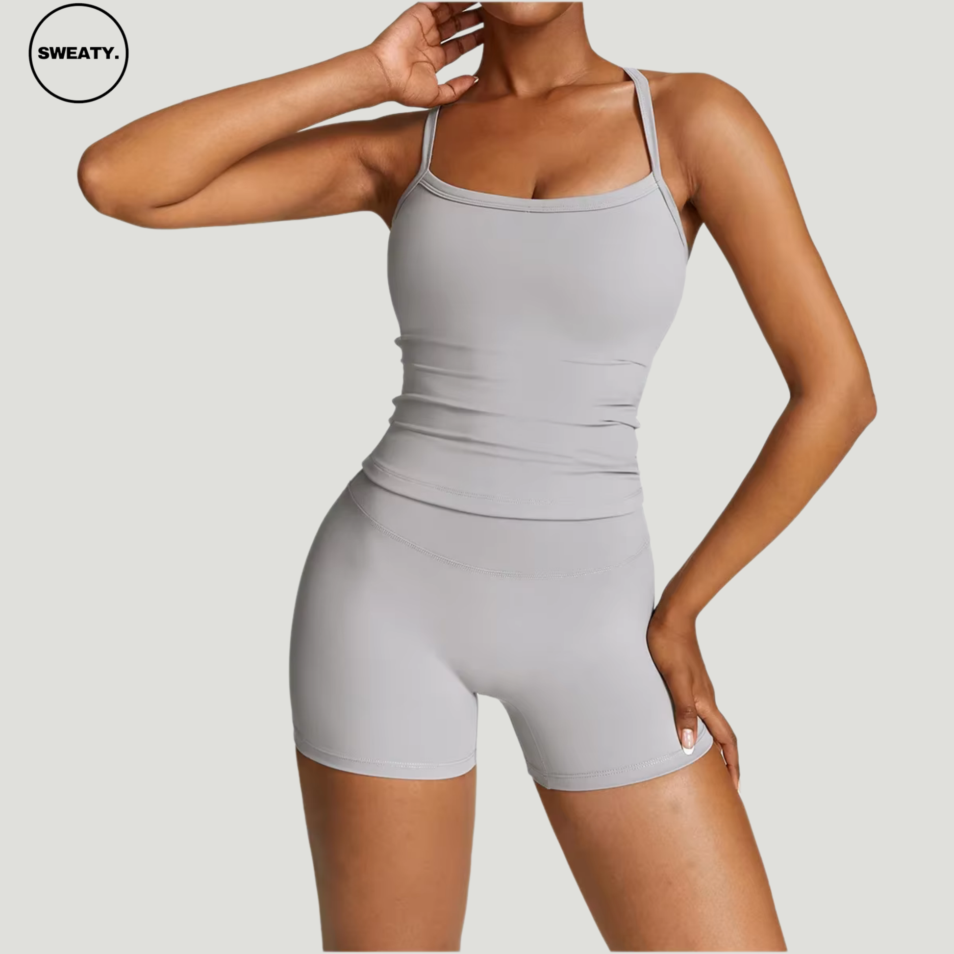 Frost grey seamless yoga set by SWEATY - Women's side pose view highlighting the sleek and flexible design, ideal for yoga, running, and fitness. SWEATY activewear made with breathable and moisture-wicking fabric for superior performance.