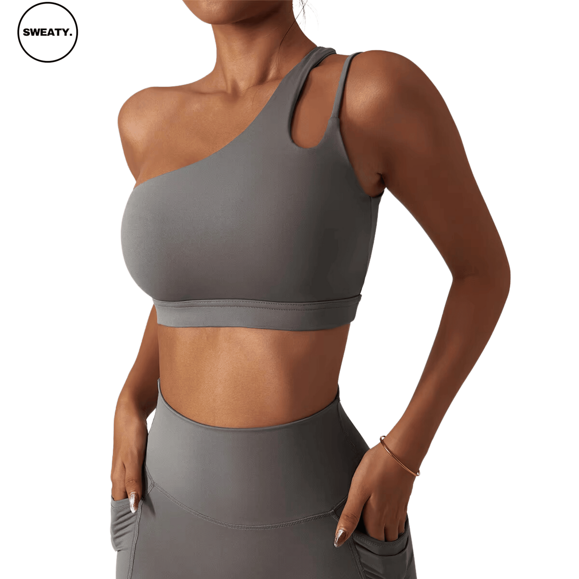 Side view of a gray Asymmetrical Double Strap Sports Bra by SWEATY, featuring a stylish one-shoulder design with dual straps for support, providing a modern and sleek look for activewear.