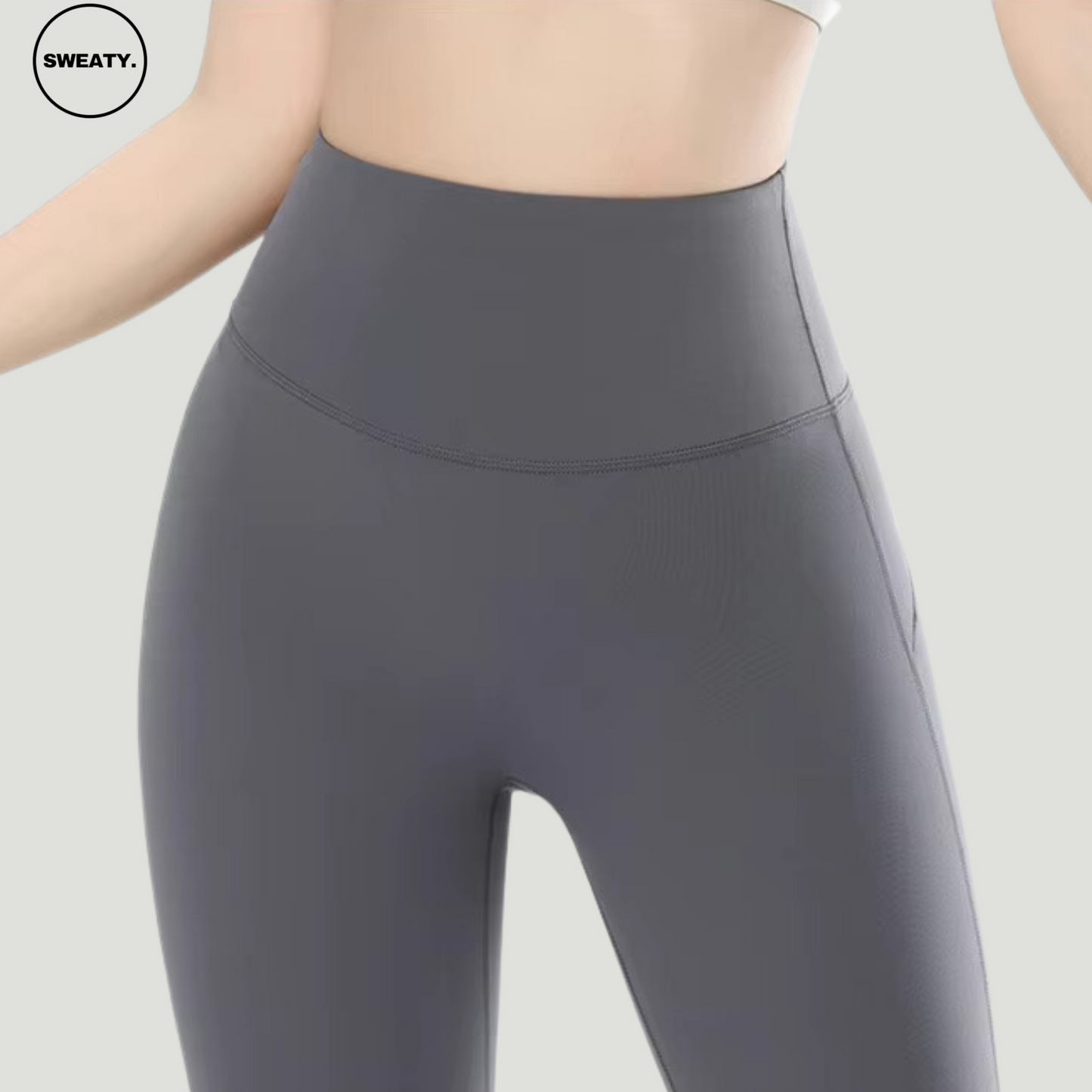 Gray High Waist Slim Yoga Pants by SWEATY - Close-up view highlighting the high-waisted, form-fitting design. Ideal for yoga, fitness, and casual wear. These SWEATY yoga pants feature moisture-wicking, breathable fabric for optimal comfort and flexibility during workouts.