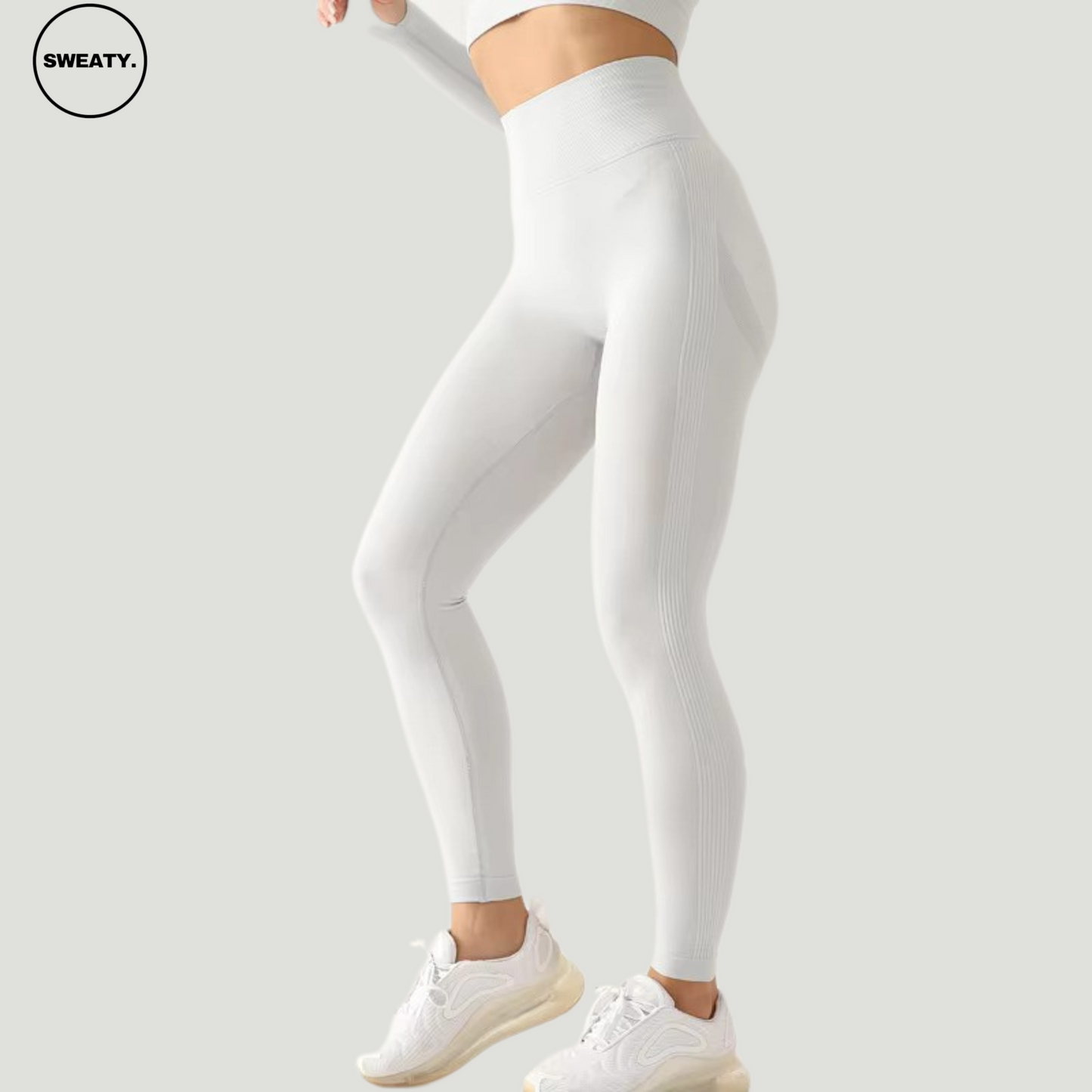 Side profile of Gray seamless high-waist leggings by SWEATY, designed for flexibility and comfort during workouts, featuring a snug fit and stylish look.