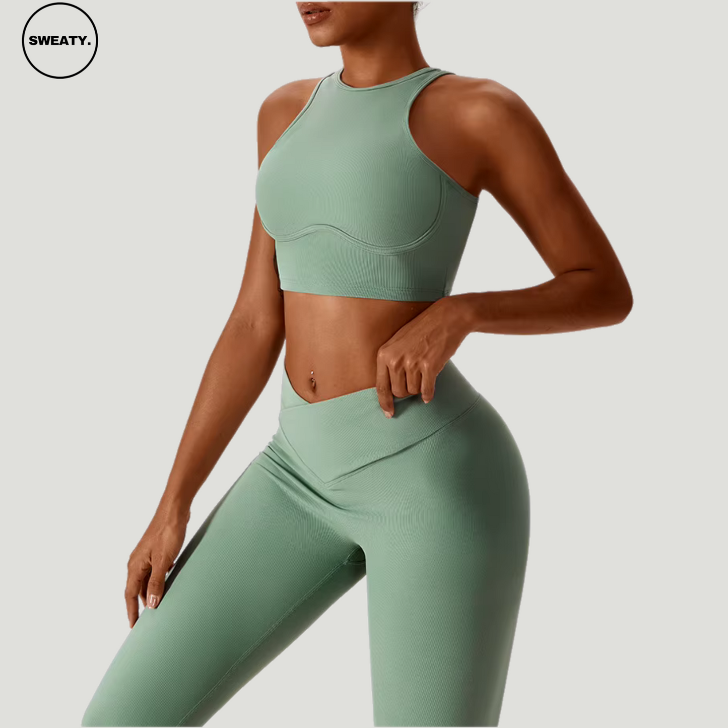 Green seamless sportswear set by SWEATY – side view showing the supportive sports bra and high-waisted leggings. Designed with breathable fabric for fitness, yoga, and running