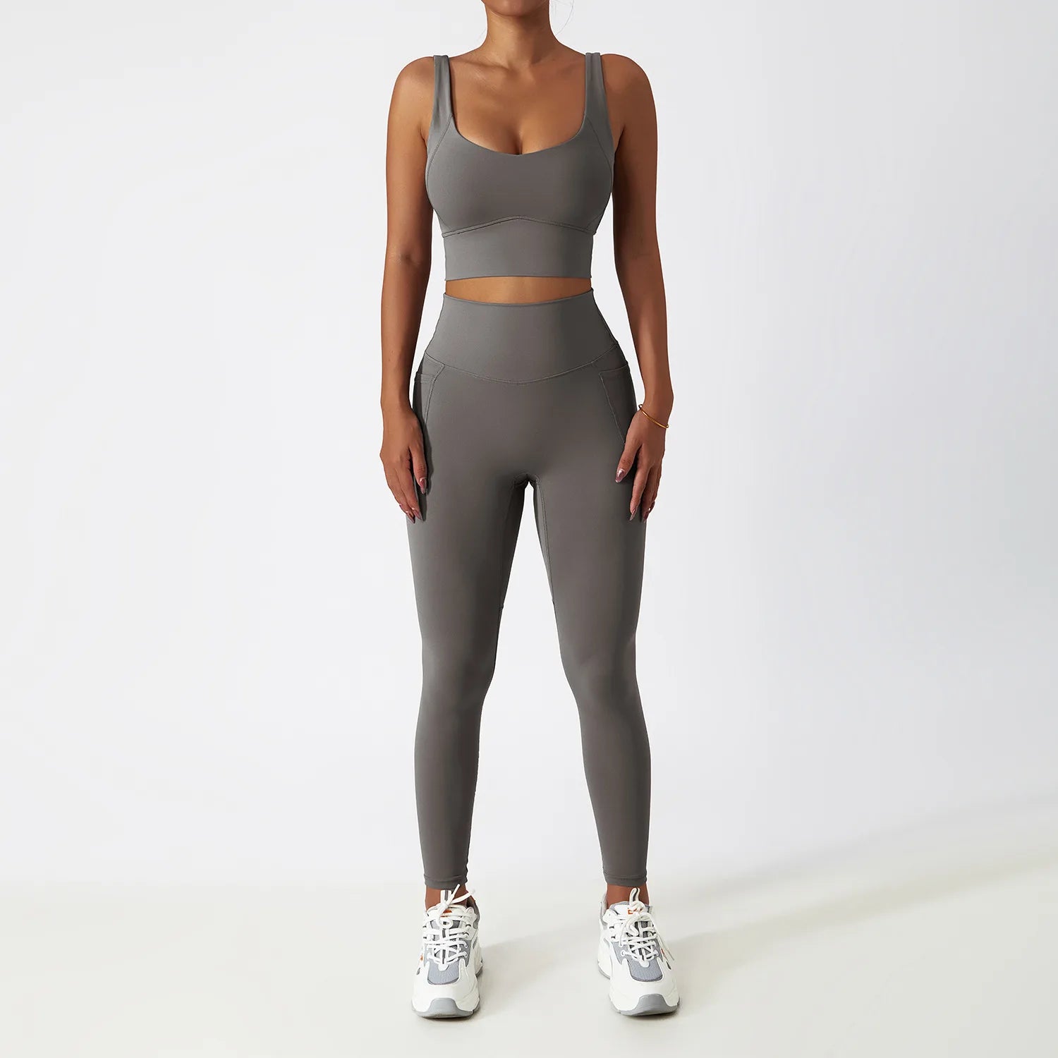 Grey seamless tracksuit set by SWEATY - Women's high-waist leggings and supportive sports bra made from breathable, moisture-wicking fabric. Ideal for yoga, running, and fitness, ensuring comfort and flexibility during workouts.