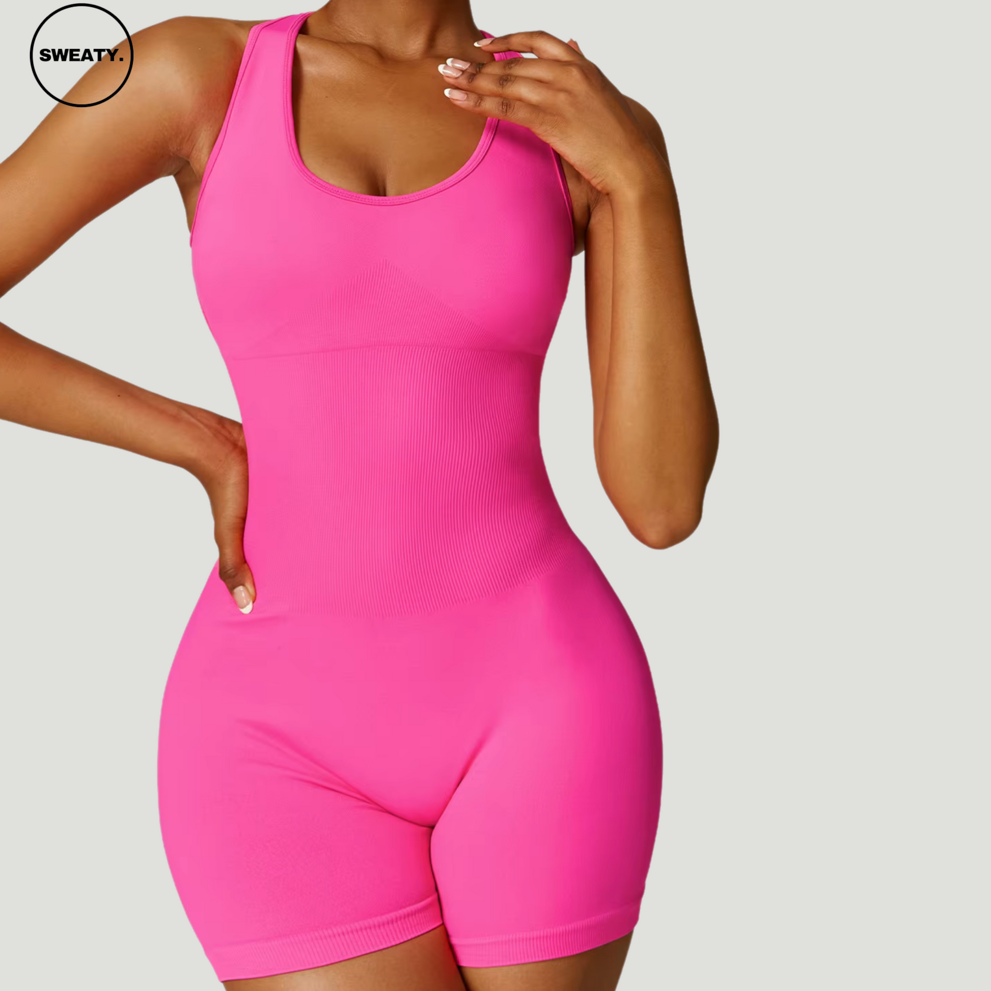 Hot pink seamless gym shortie jumpsuit by SWEATY - Women's close-up front view highlighting the sleek, sculpting design. Made for high-intensity workouts, this jumpsuit offers a seamless construction that ensures comfort and flexibility.