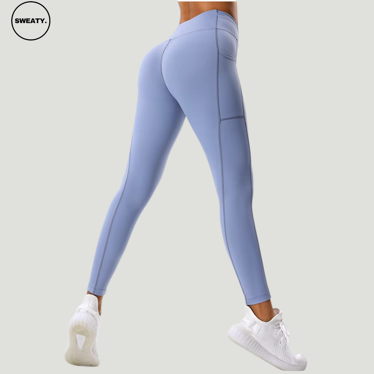 Side-back view of the Light Blue Hips Yoga Legging by SWEATY, showcasing the full-length fit and contoured design for enhanced support. The leggings feature sleek side pocket details and a high-waisted structure for a flattering silhouette, perfect for both active and casual wear.