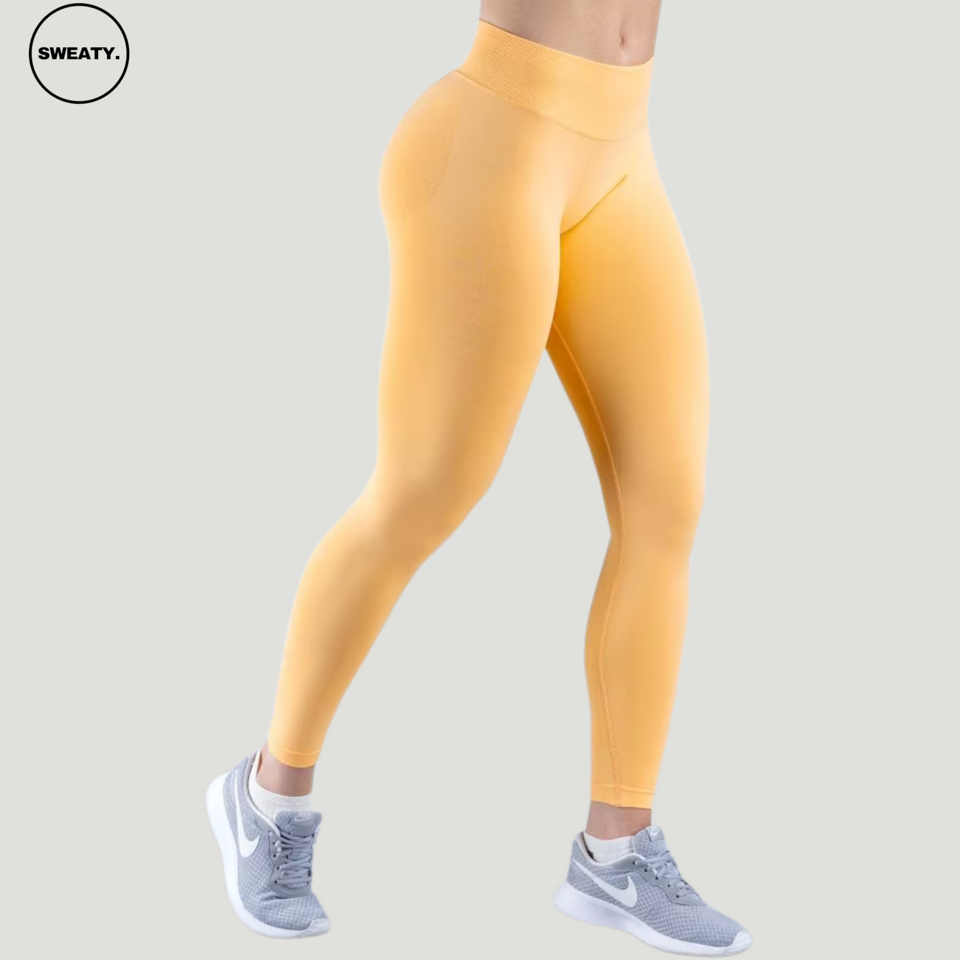 SWEATY Peach Sorbet High Waist Scrunch Butt Yoga Leggings, front side angle view highlighting the high waistband and seamless fit.