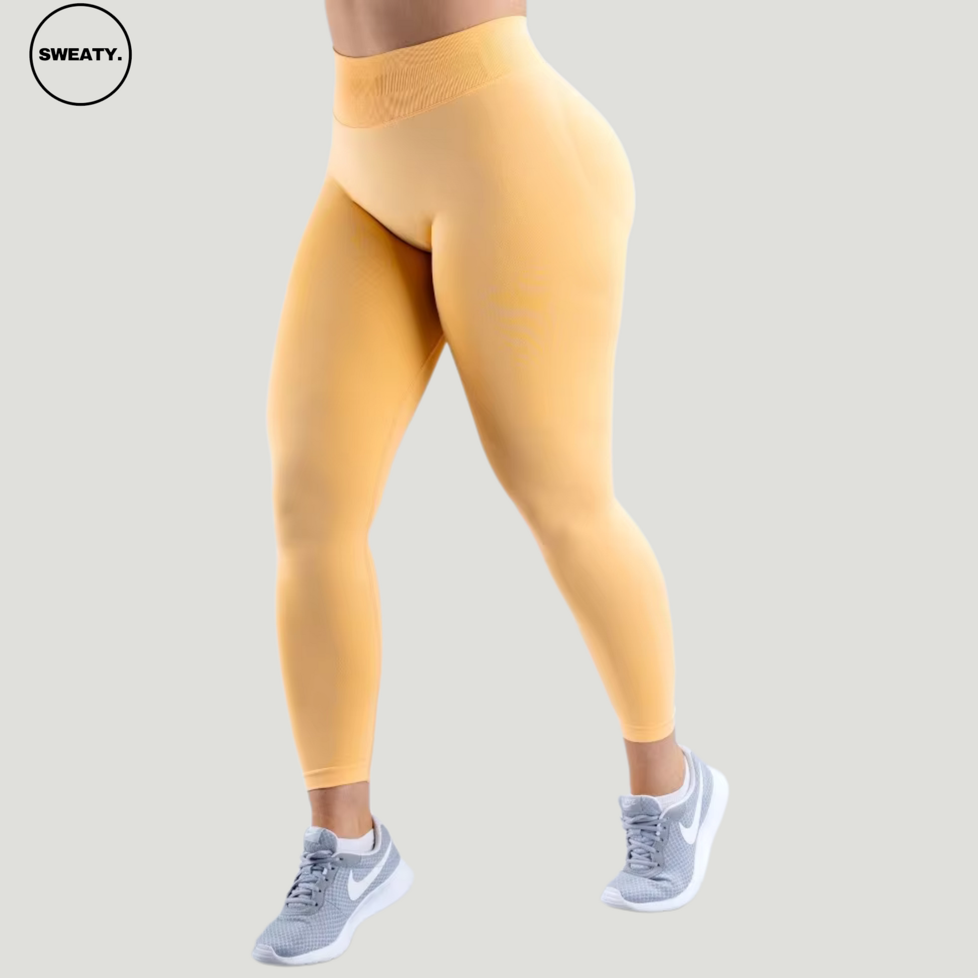 SWEATY Peach Sorbet High Waist Scrunch Butt Yoga Leggings, side angle view showing the contour fit and seamless waistband.