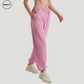 Pink wide-leg fleece-lined sweatpants by SWEATY - Women's walking side view showing a relaxed fit, soft fleece interior, and elastic waistband. Ideal for casual wear or lounging, these sweatpants offer comfort and style with convenient side pockets.