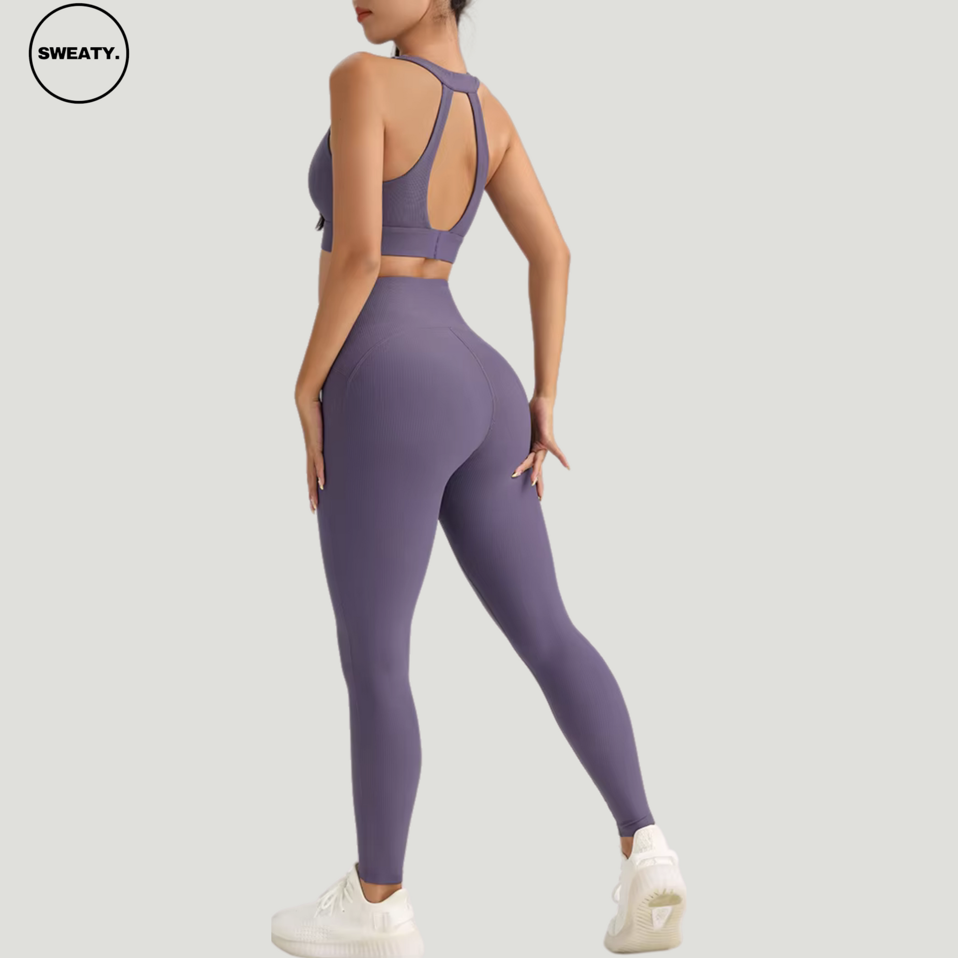 Purple-Cross-Yoga-Suit-Back-View-by-SWEATY - Women's bold and vibrant Purple Yoga Suit, featuring an elegant cross-back design for enhanced support and style during fitness activities. Perfect for those looking to stand out in the gym with both color and performance.