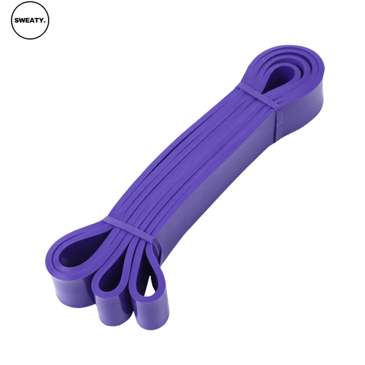 Purple fitness resistance band displayed from a top angle. Durable and versatile, perfect for strength training, stretching, and resistance exercises. SWEATY fitness equipment for effective workouts at home or in the gym.