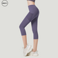 Purple High Waist Mesh Pocket Capri Pants by SWEATY, side view highlighting the mesh paneling and practical mesh pockets. These capri-length leggings are designed with a high waist for a comfortable, secure fit, ideal for yoga and activewear.