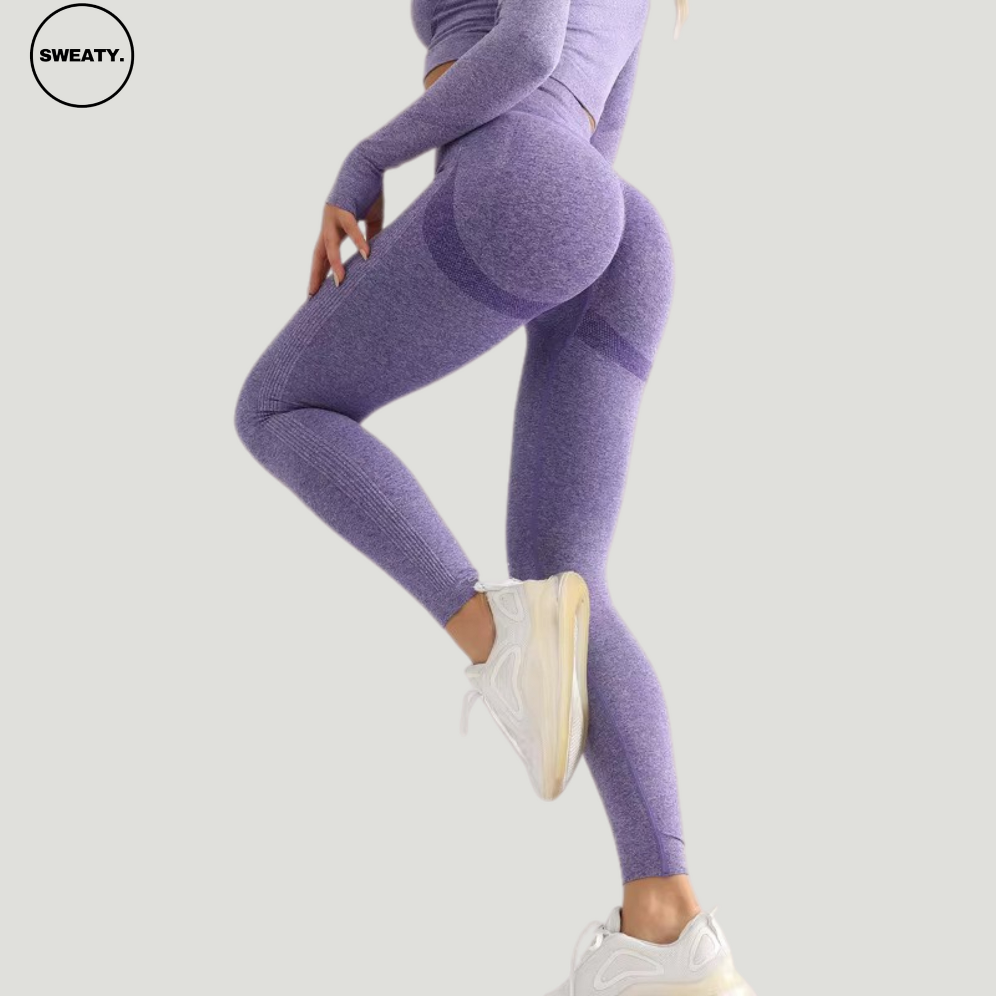 Side angle view of Purple seamless high-waist leggings by SWEATY, highlighting the sculpted fit and high-rise waistband.