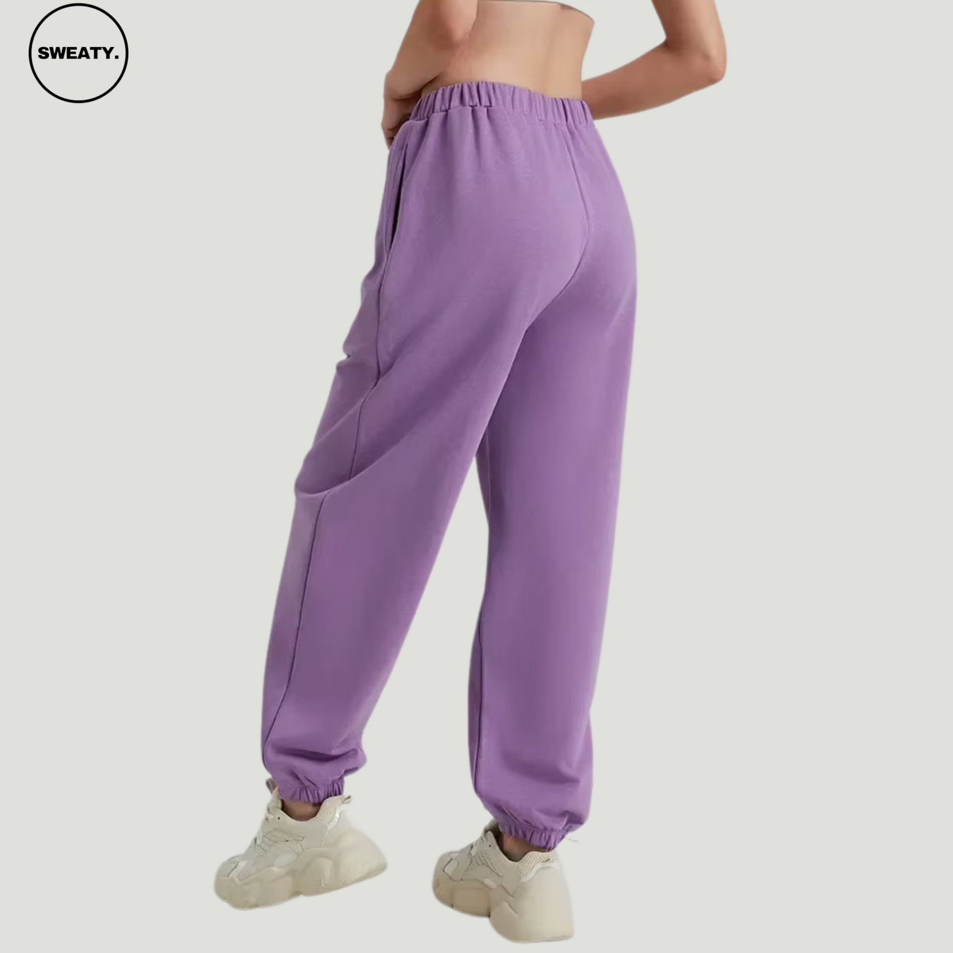 Purple wide-leg fleece-lined sweatpants by SWEATY - Women's side view showcasing relaxed fit and soft fleece lining. Designed for comfort and style, these sweatpants feature an elastic waistband and side pockets, ideal for lounging or casual wear.