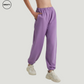 Purple wide-leg fleece-lined sweatpants by SWEATY - Women's side walking view showcasing a relaxed fit and fleece-lined interior. Perfect for lounging or casual outings, these sweatpants feature an elastic waistband for comfort and practicality.