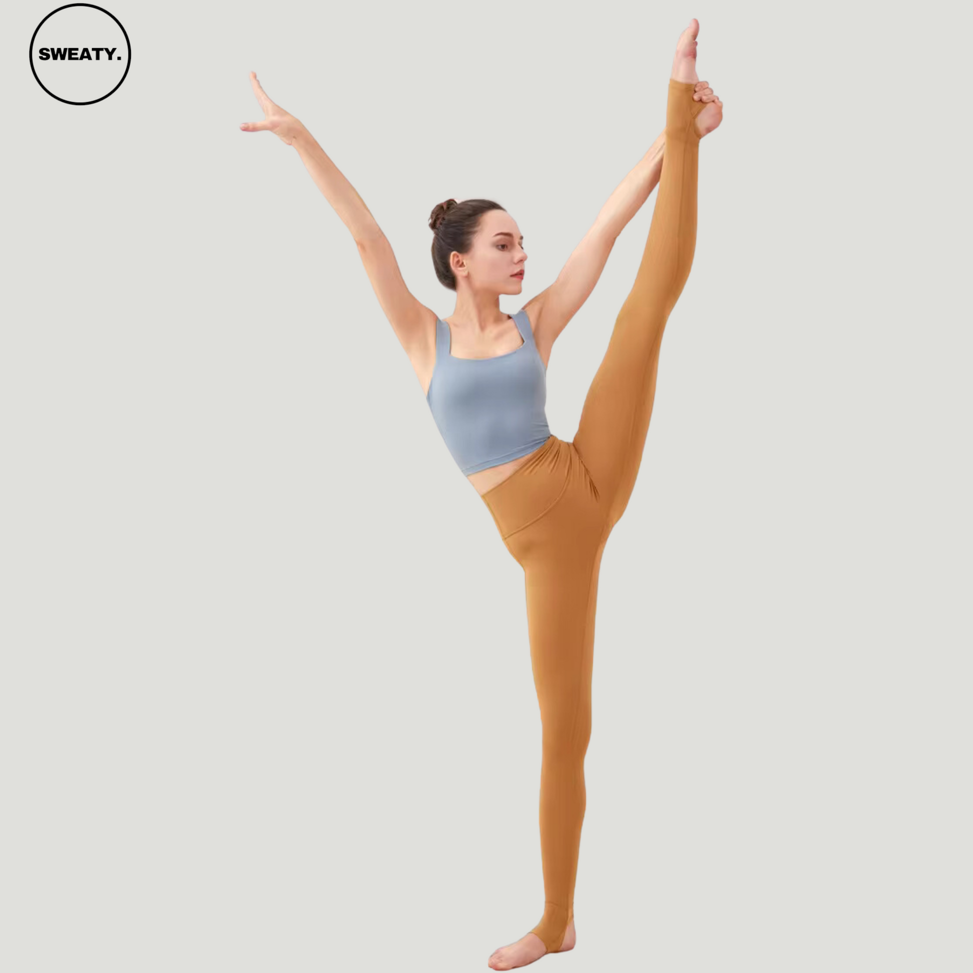 Model performing a high leg stretch while wearing Saddle Breathable Stirrup Yoga Leggings by SWEATY. The leggings are designed for flexibility, making them ideal for yoga and fitness. The model’s pose highlights the leggings’ stretch and comfort, ensuring full range of motion.