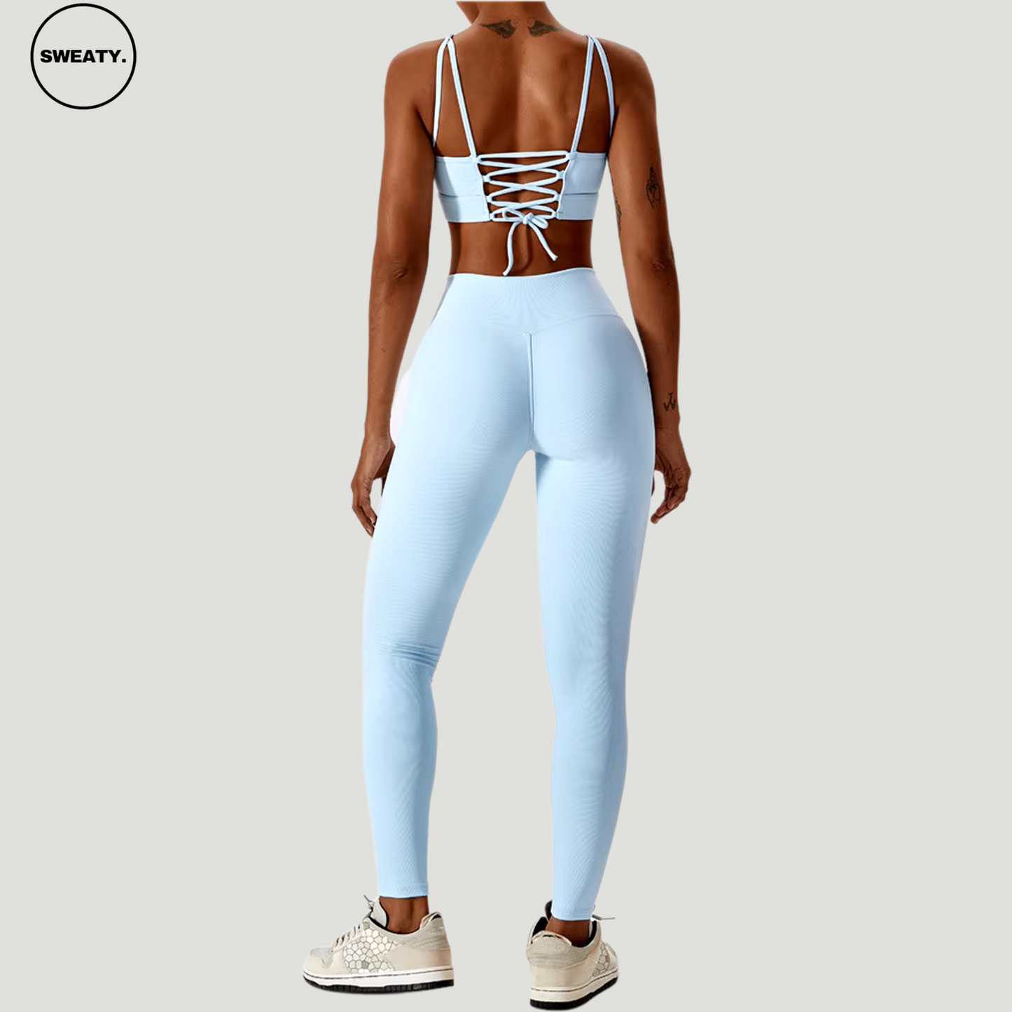 Sky Blue seamless sportswear set by SWEATY – back view featuring a strappy sports bra and high-waisted leggings. Made from flexible, quick-drying fabric for yoga, running, and gym workouts.