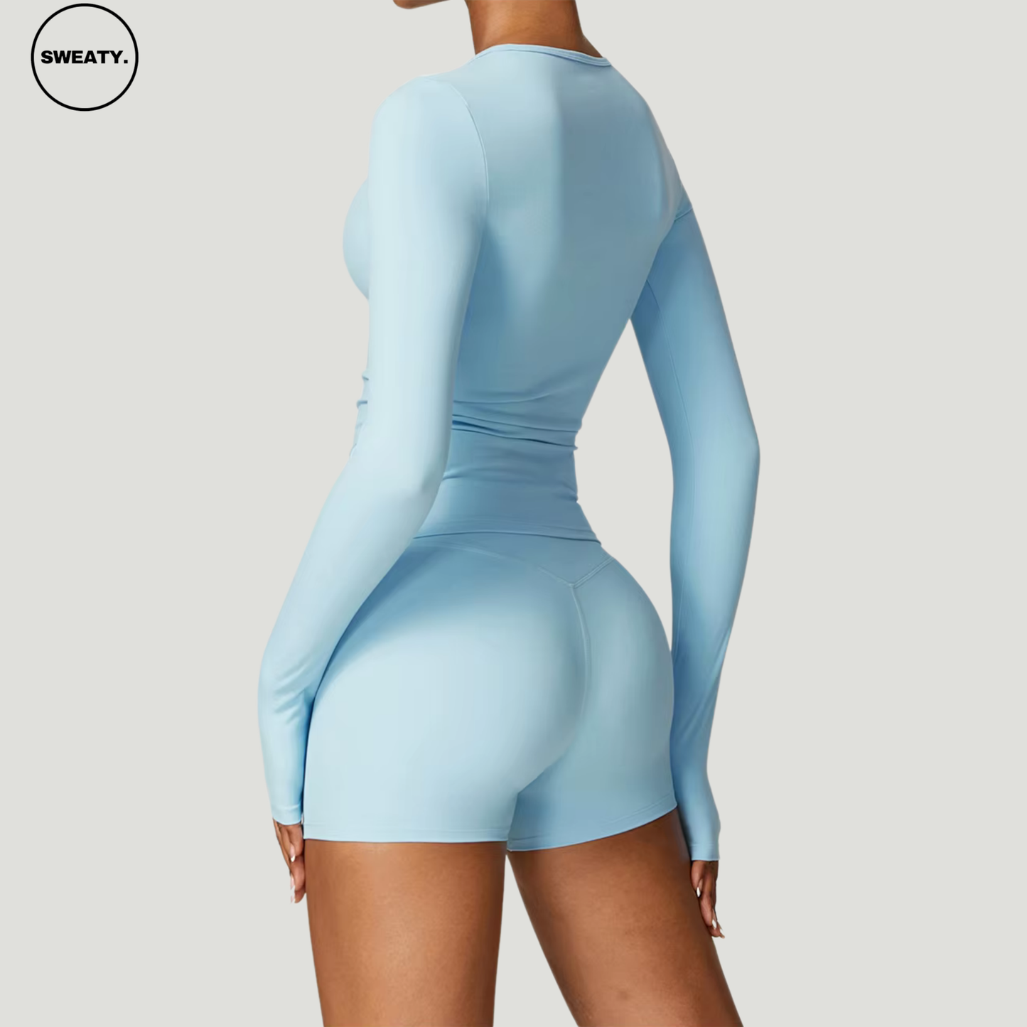 Sky Blue seamless yoga set by SWEATY – back view of the long-sleeve crop top paired with high-waisted shorts. Designed with moisture-wicking and quick-dry fabric for enhanced comfort during yoga and fitness activities