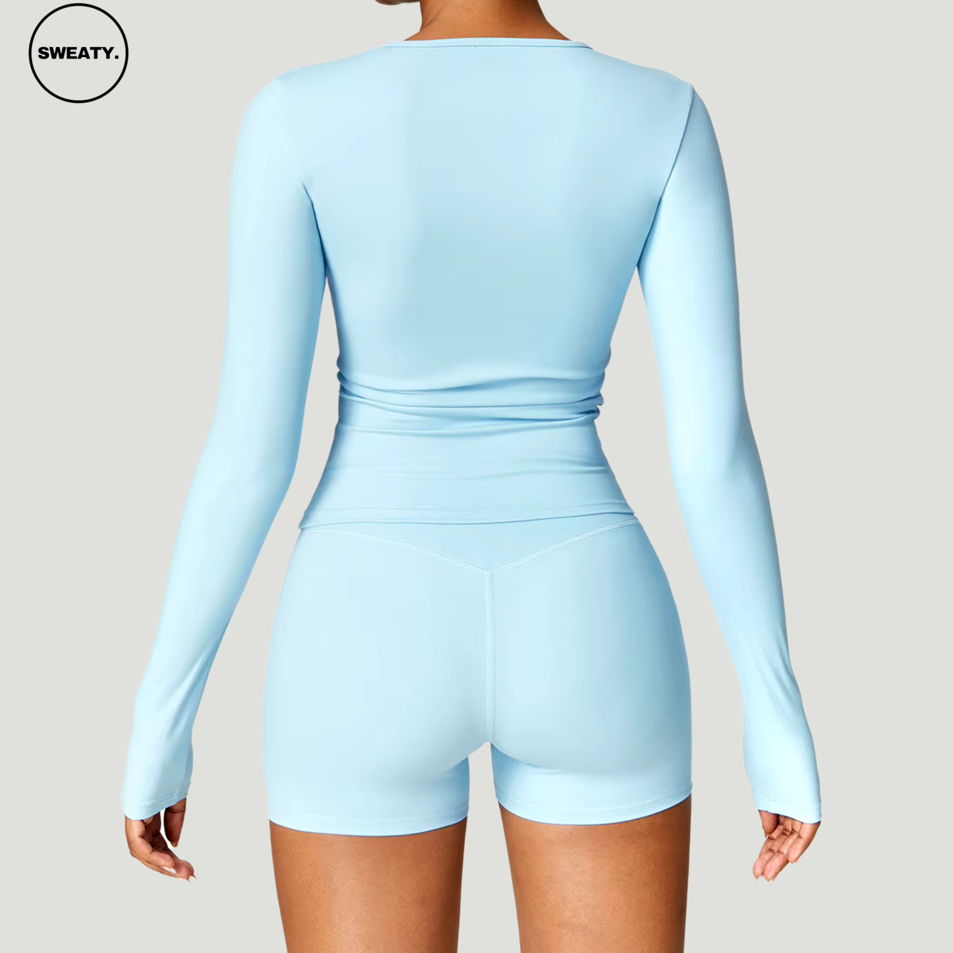 Sky Blue seamless yoga set by SWEATY – full-body back view showcasing the long-sleeve crop top and high-waisted shorts. Ideal for yoga and fitness, featuring breathable, flexible fabric for optimal movement.